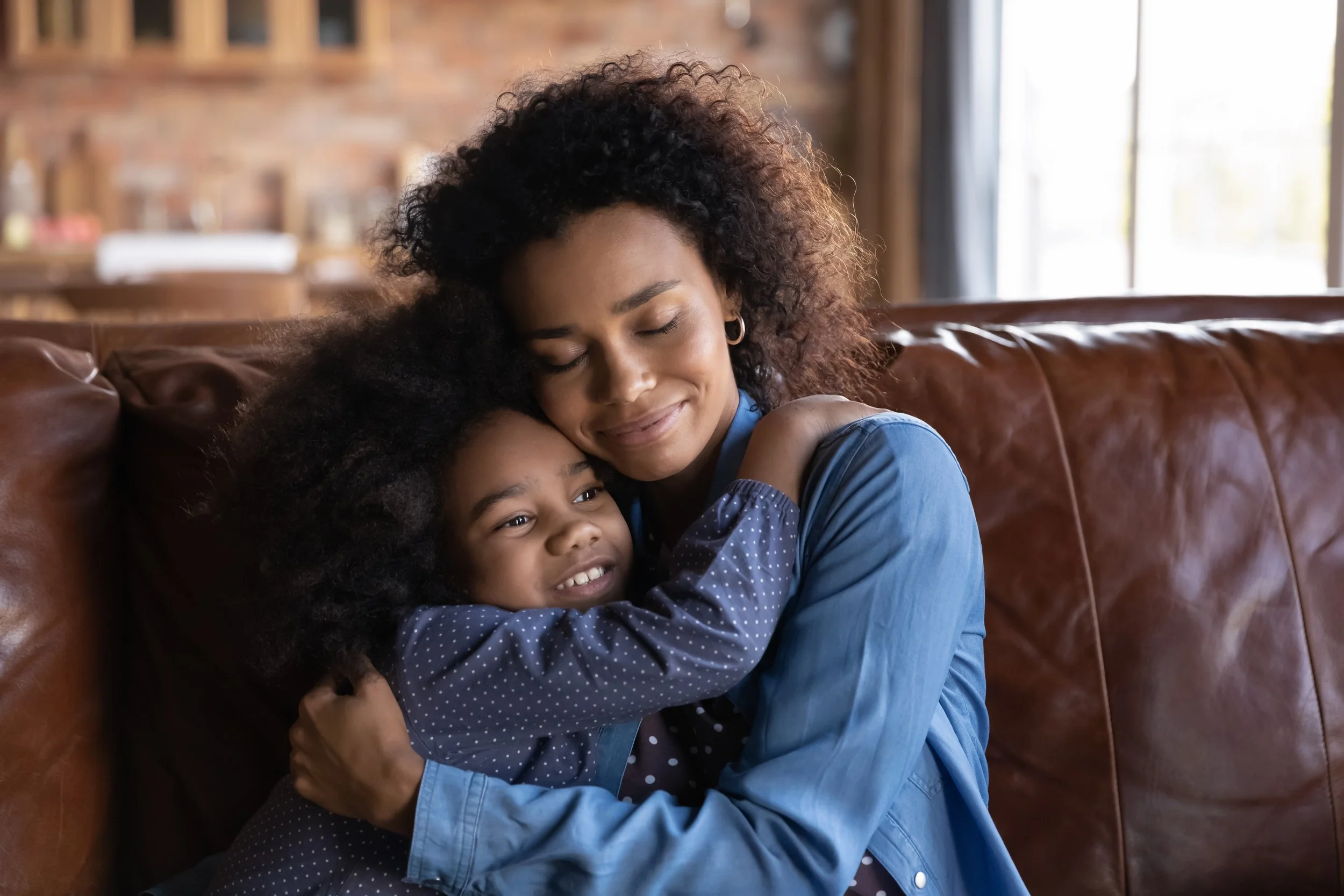 Mother hugging and comforting her daughter