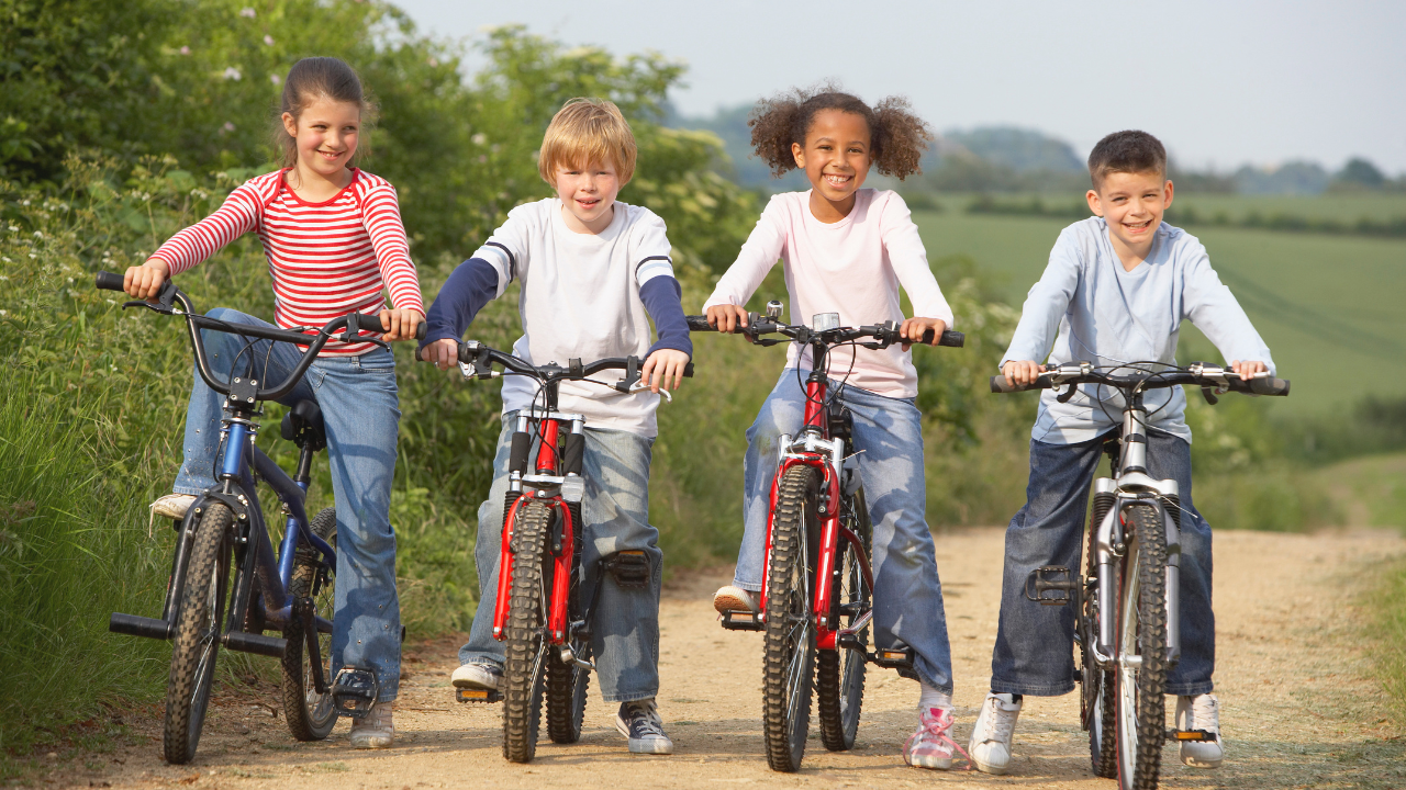 4 kids on their bikes without a helmet.