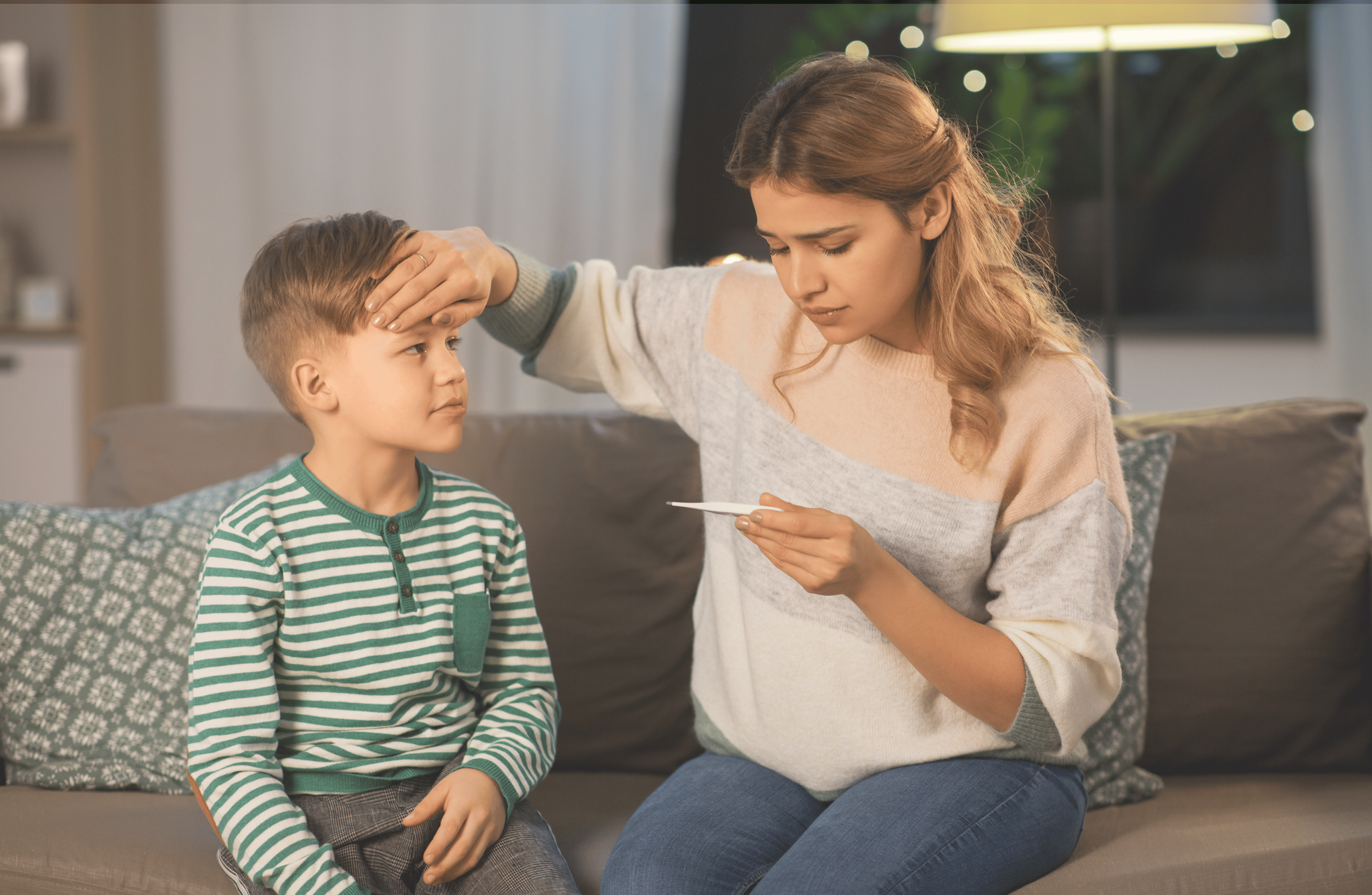 Parent checking child's temperature at home after a pediatric visit.