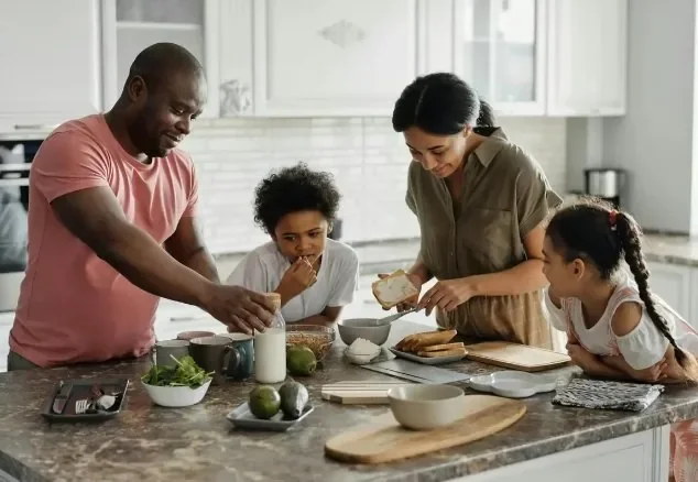 Family preparing food together at the kitchen counter