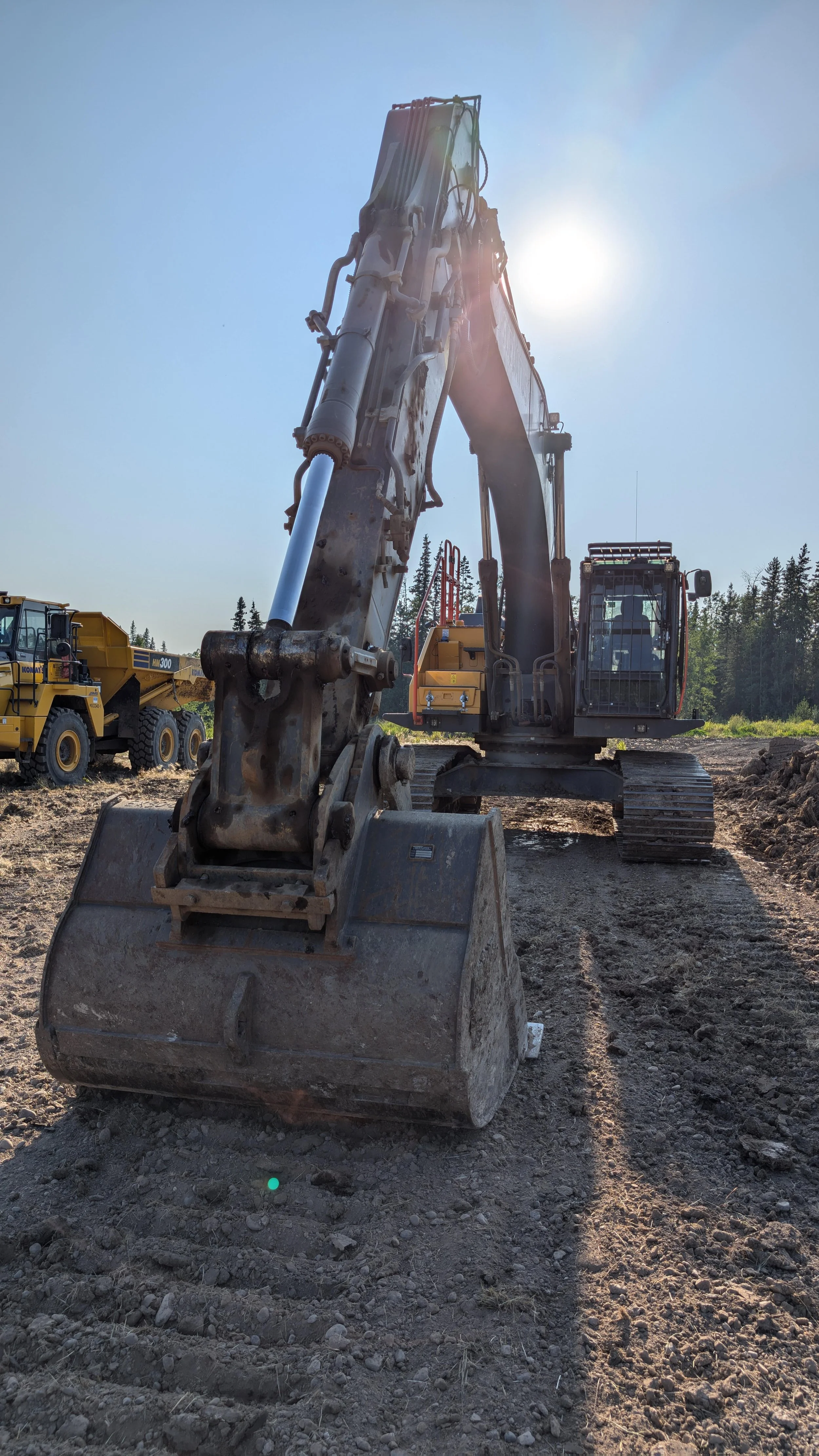trackhoe with rock truck in tow