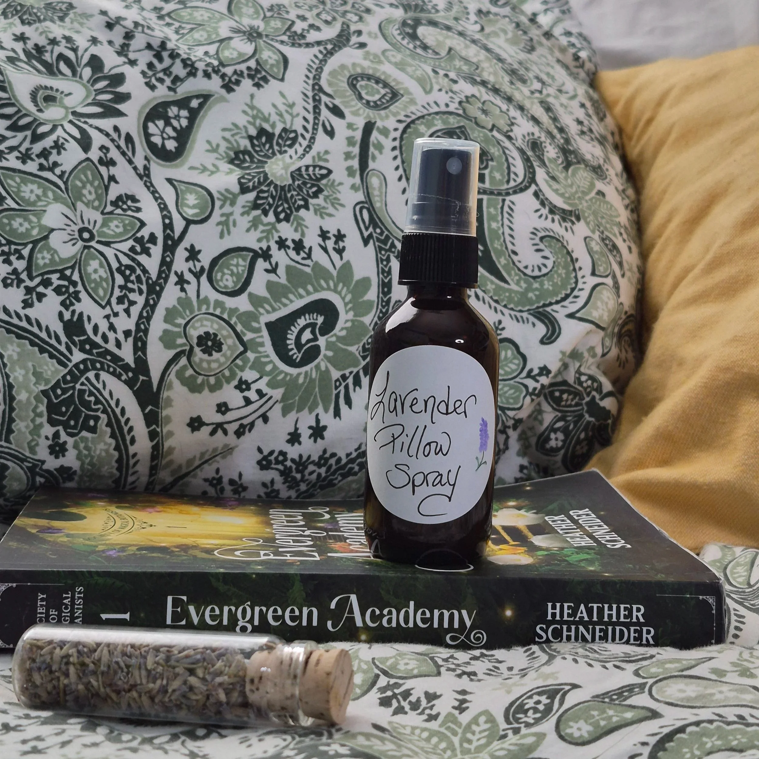 Lavender Pillow Spray Aromatic Spritzer Bottle Resting on the book Evergreen Academy