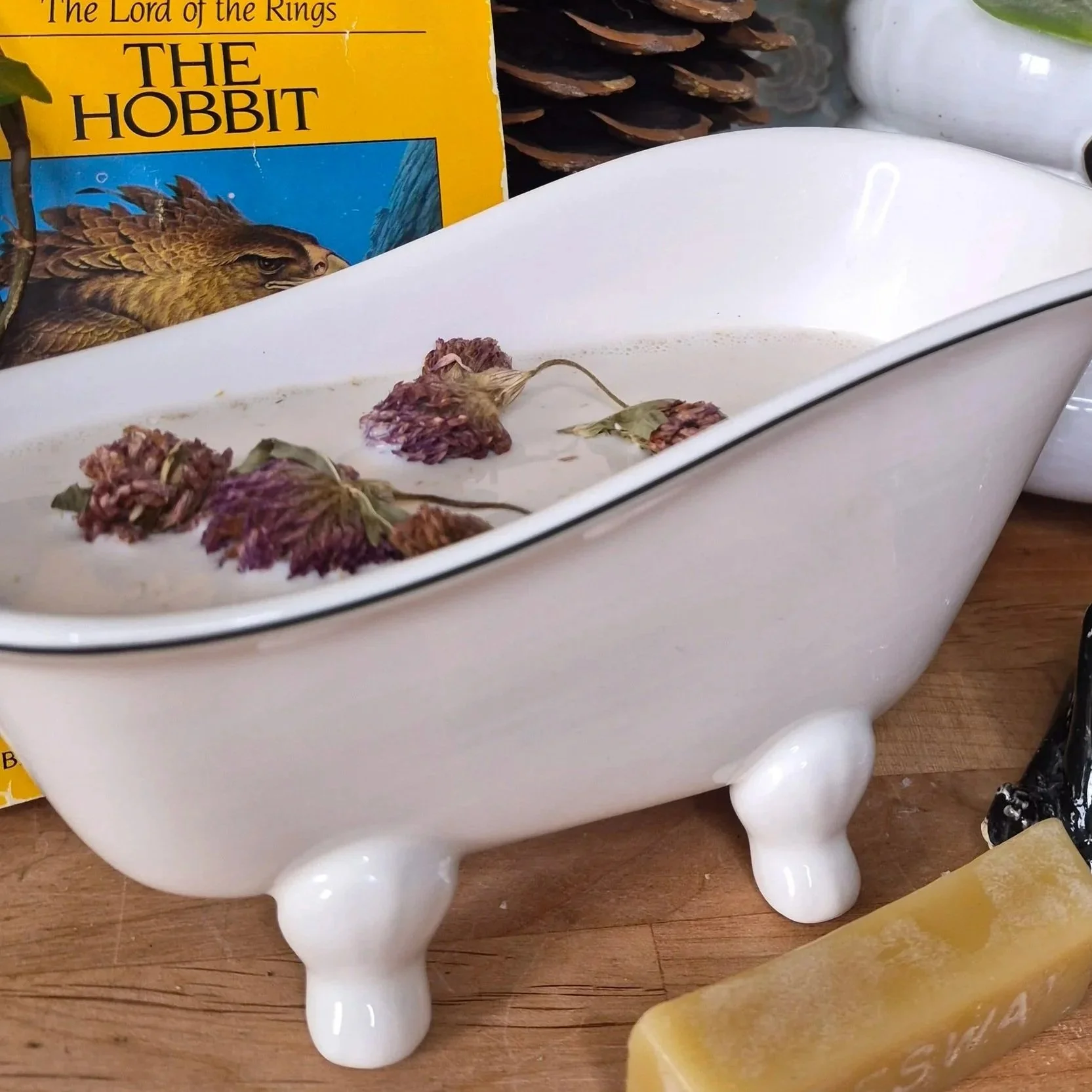 minature bathtub filled with honey milk bath