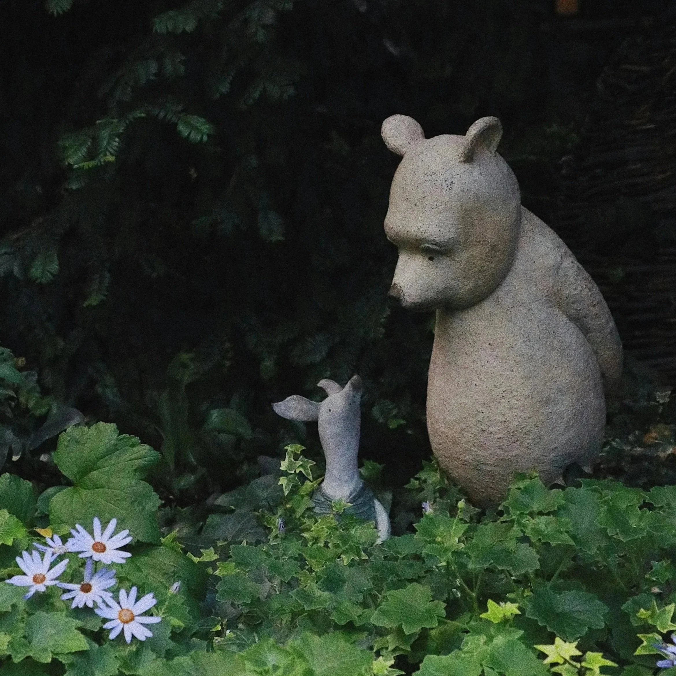 status of Winnie the Pooh and Piglet in a garden