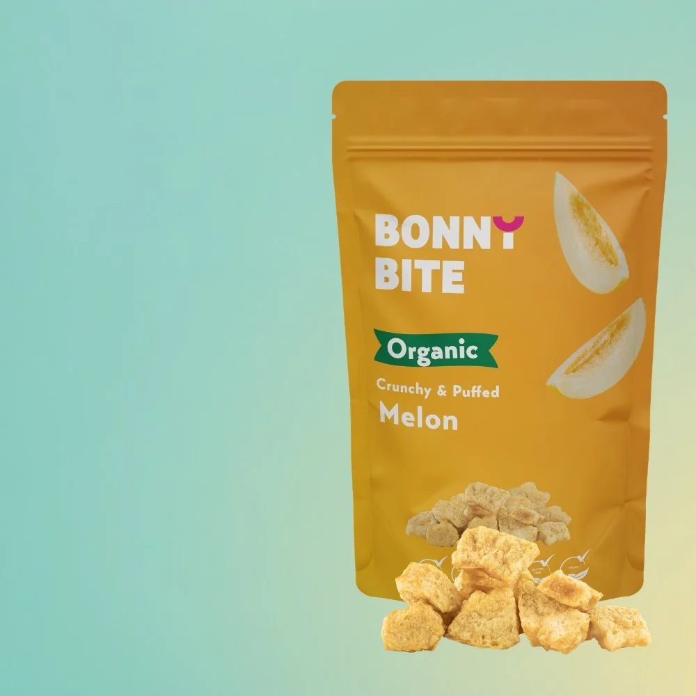 Pack of Bonny Bite Organic Crunchy & Puffed Melon with puffed melon pieces displayed on a bright blue back