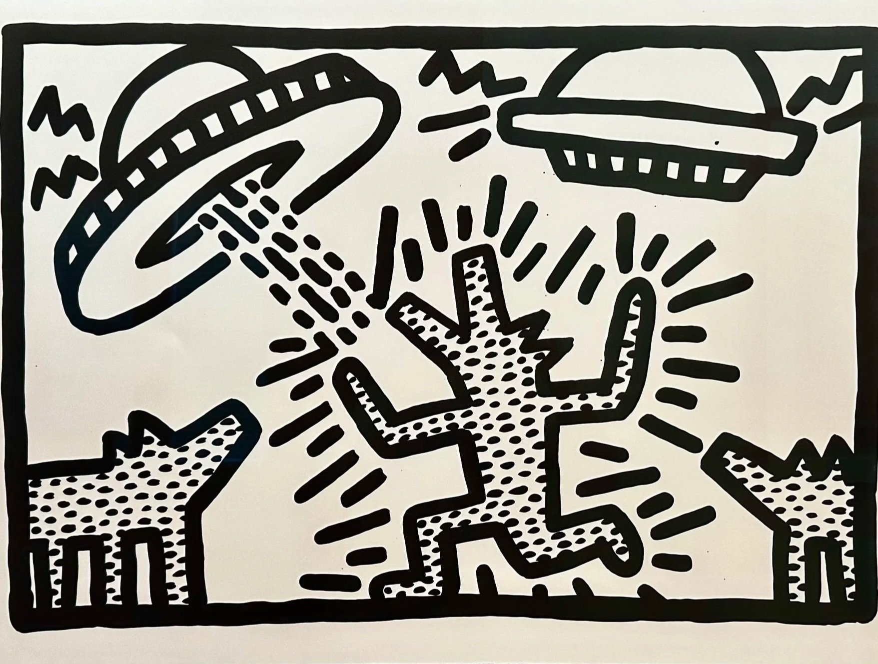 Black and white drawing of a UFO beaming light onto a cactus with other cacti and a flying saucer in the background.