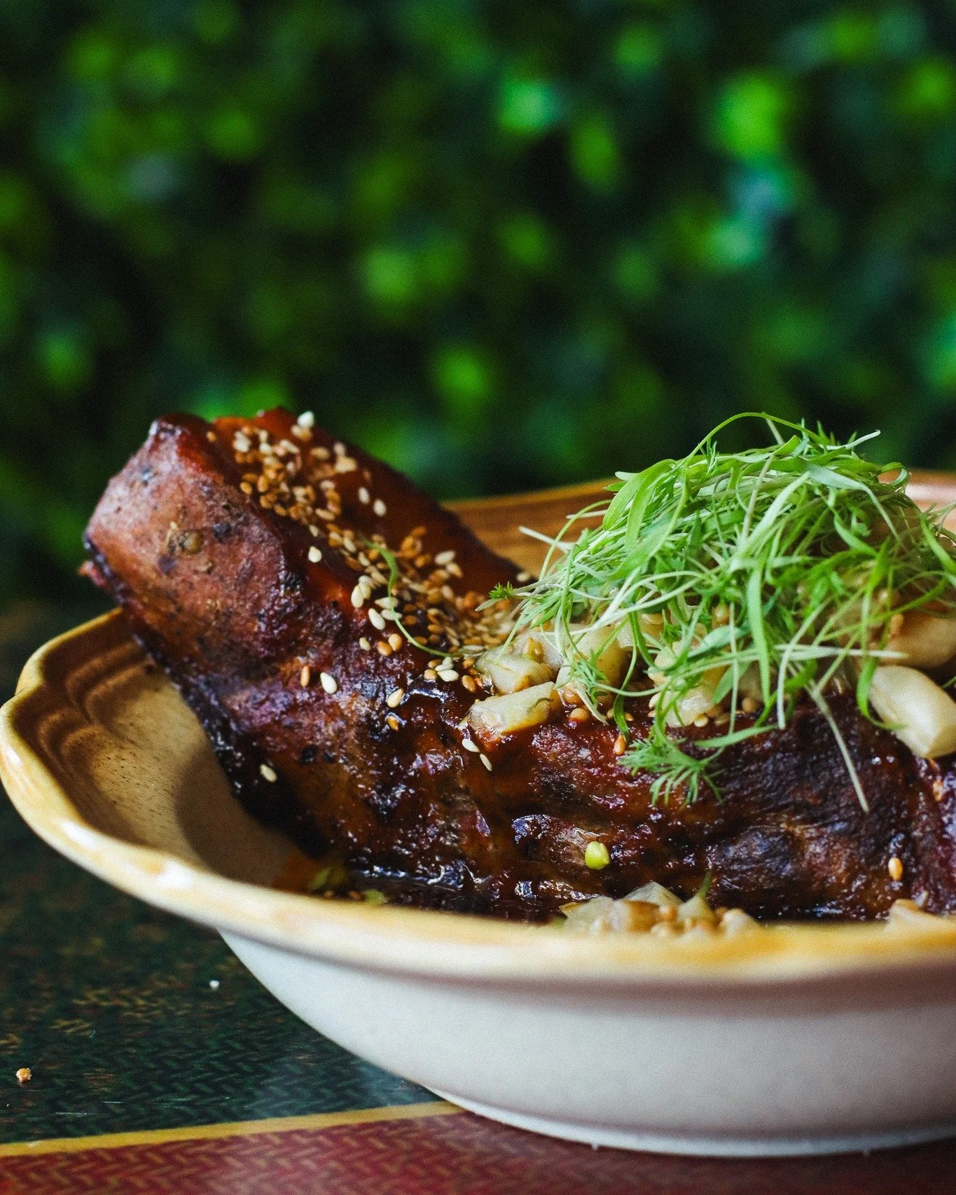 :: Open Pit Pork Belly:: Pastrami-rubbed and braised all day until it&rsquo;s melt-in-your-mouth tender, then finished with a Korean-style open pit barbecue glaze. Served with almost-burnt rapini and tahini wax bean relish.

It&rsquo;s vinegary, bitt