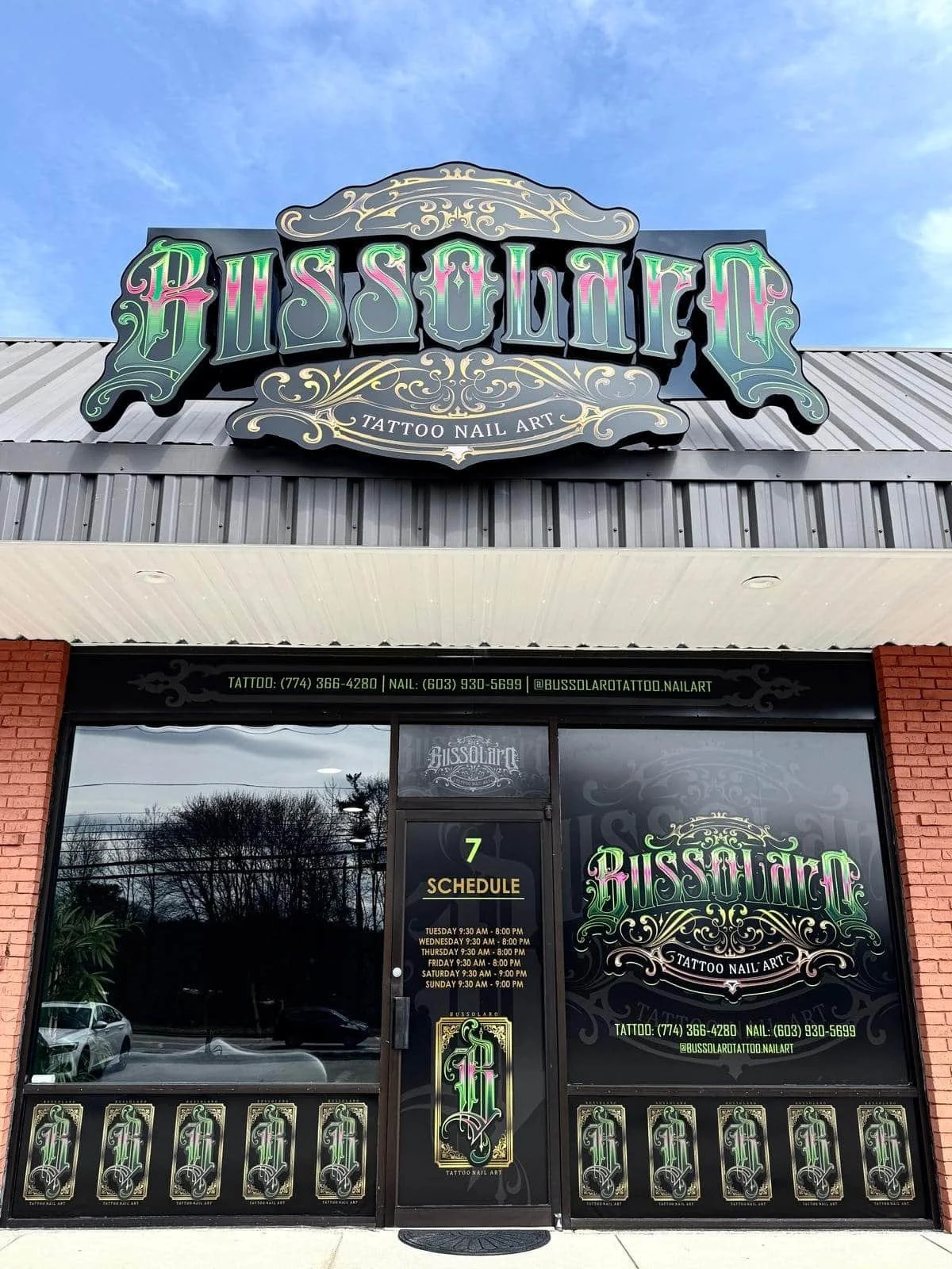 Storefront of Bussolaro Tattoo Nail Art, a tattoo studio with ornate green and gold signage above the door and windows.
