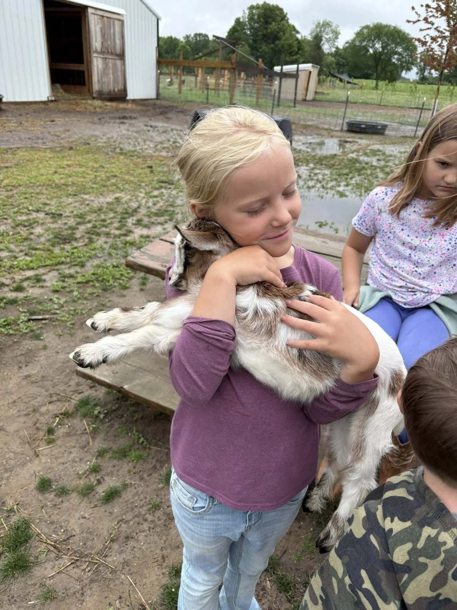 girl hugging baby goat.jpg