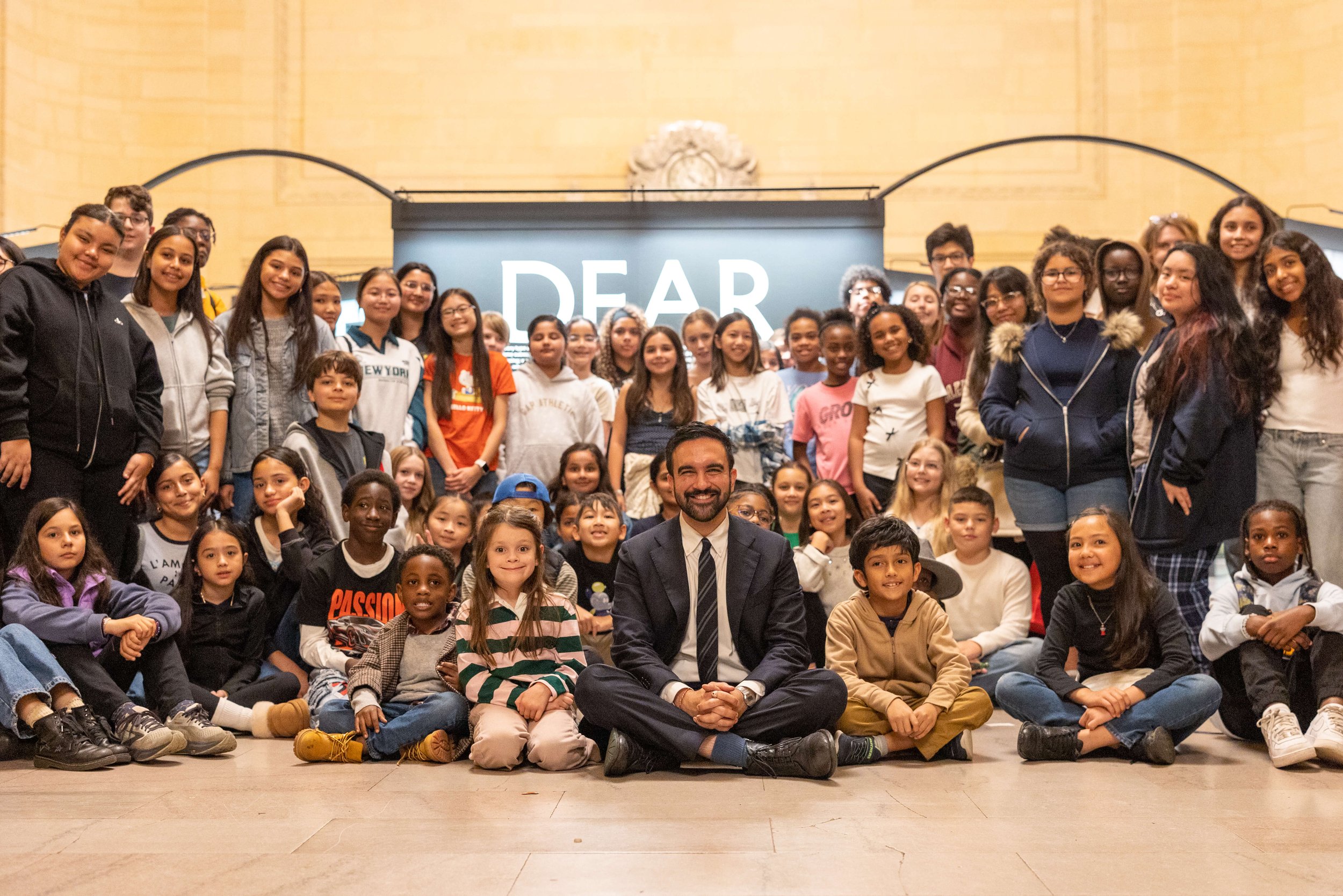 Zohran Mamdani greets the student artists while touring the exhibition. 