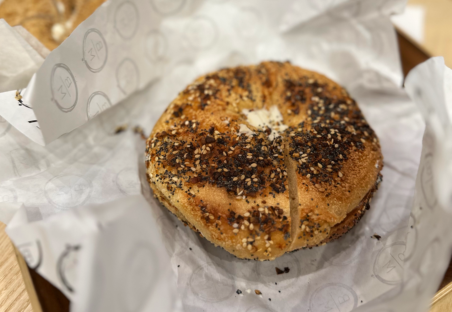 Close-up of an everything bagel with cream cheese