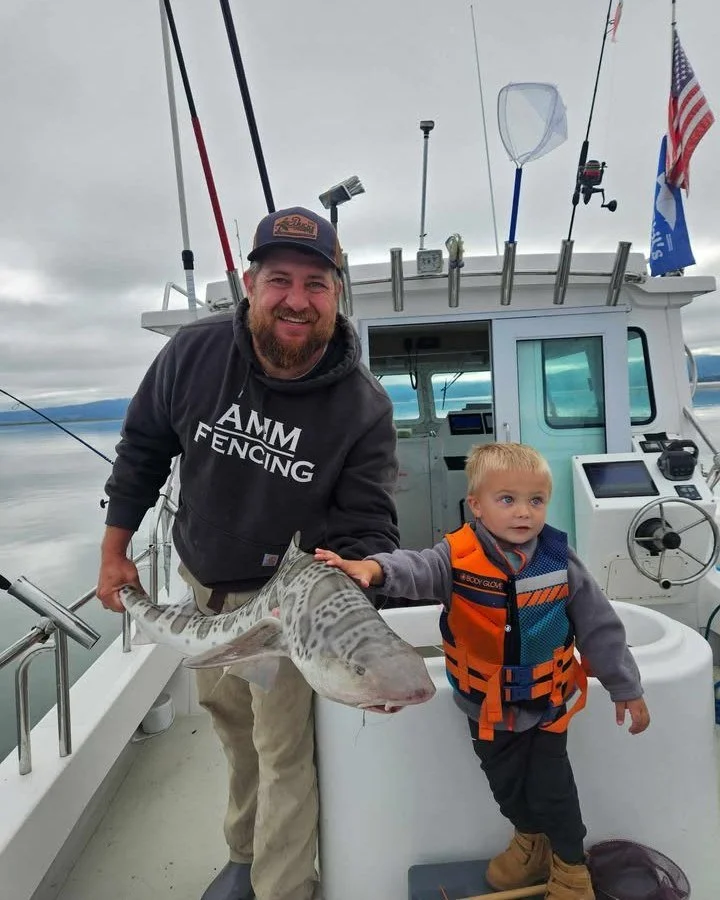 Check out this beautiful moment captured in a photo of Jared and Laramie Gadberry! They successfully caught a remarkable leopard shark in the stunning Humboldt Bay. This memory will always be cherished as the 'Biggg Sharkyy' catch. 📸
