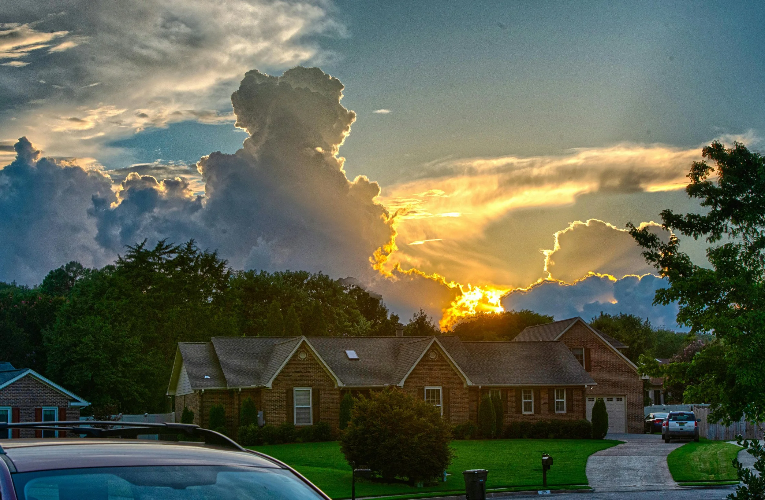 sunset through the clouds over a alabama neighborhood