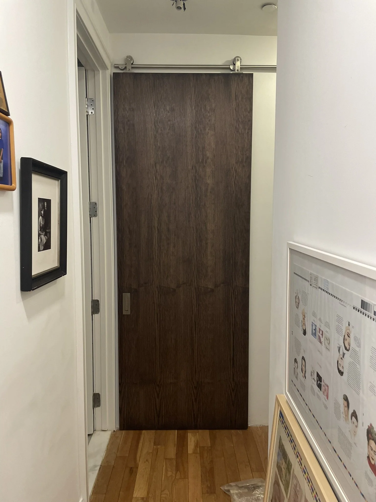 Custom sliding door with finishes to match rooms on each side. 