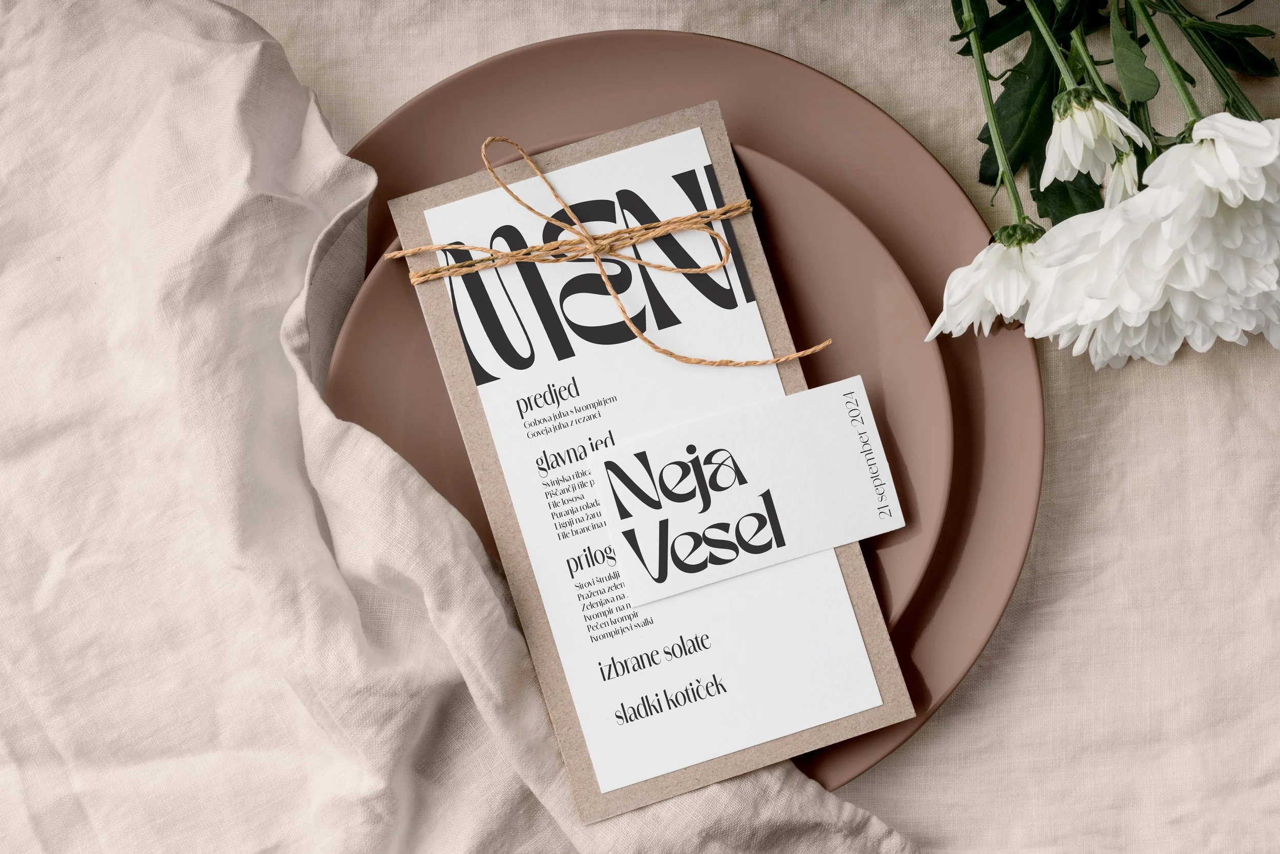 A woman sitting on a bed using a laptop in a room with wooden walls.