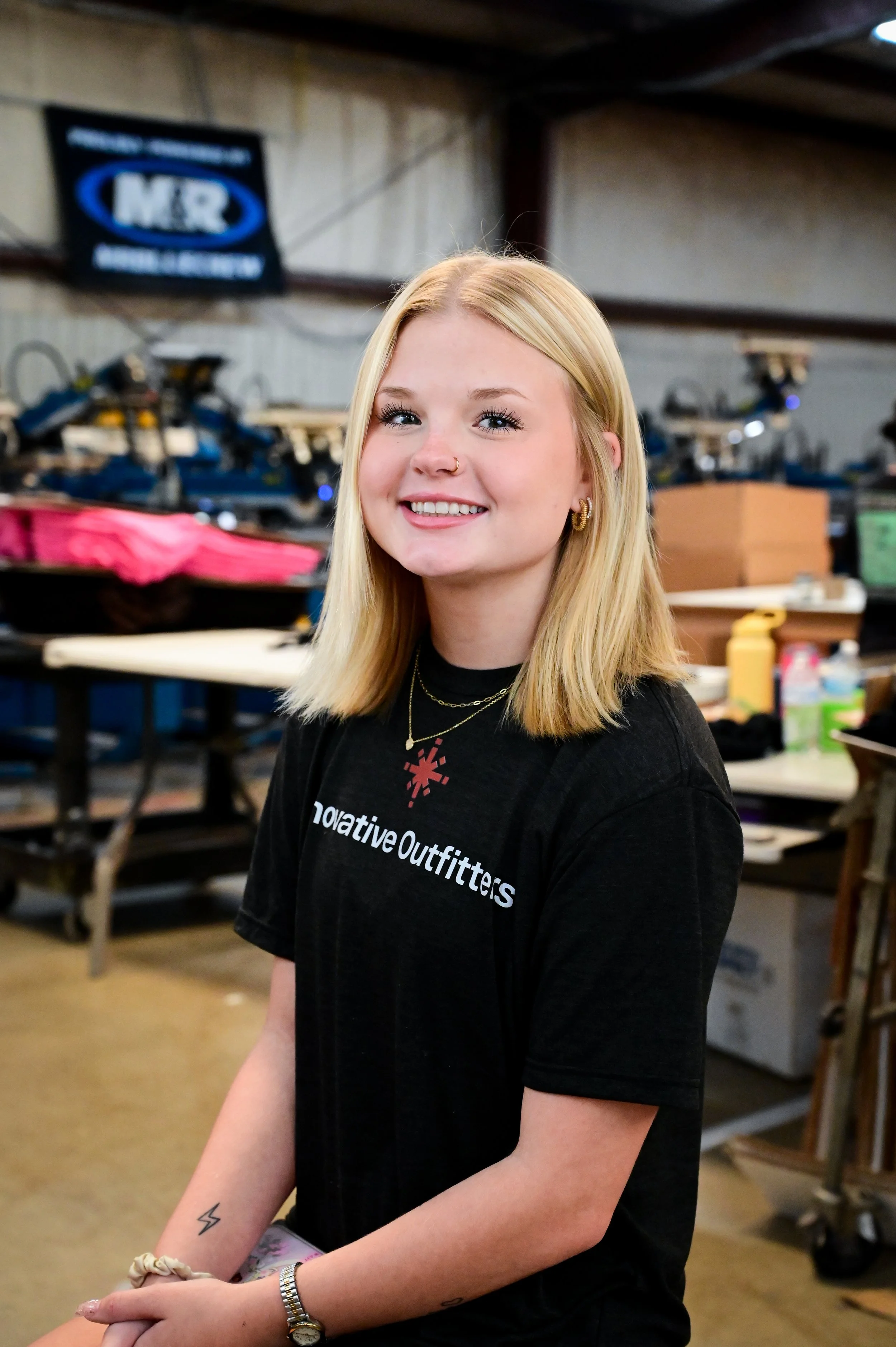 Multiple shelves filled with paint buckets, many with dried paint drips and splatters, in a variety of colors and sizes.