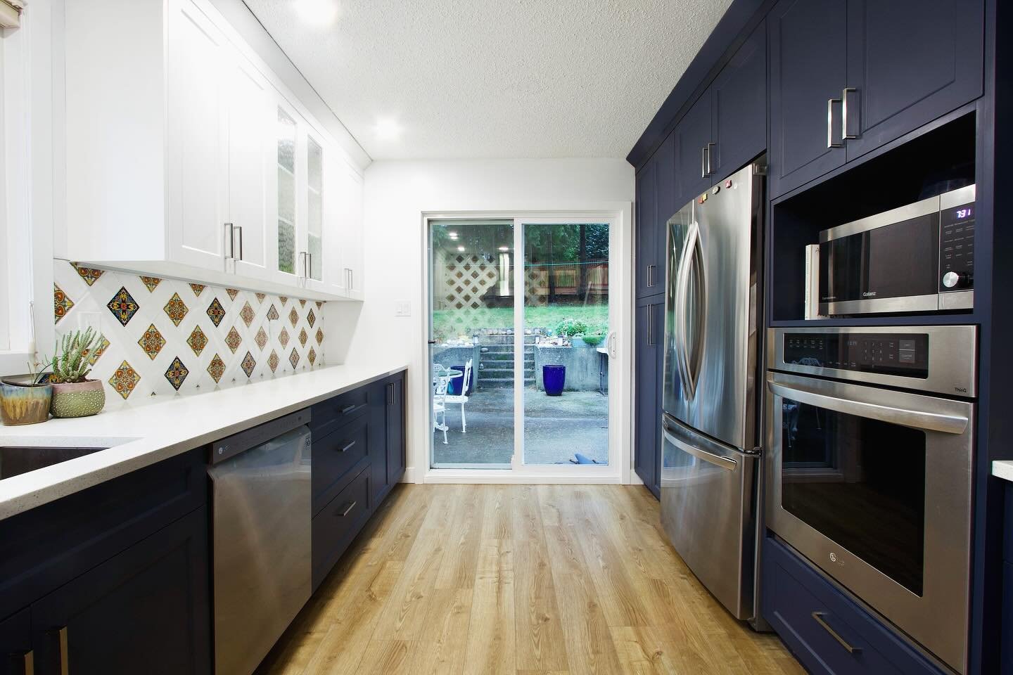 &ldquo;Paint it blue and watch it come alive.&rdquo; - ChatGPT. 
This kitchen went from simple and outdated to stunning with bold blue cabinets and a character (and sentimental) backsplash that brings the whole space to life. Bright, modern, and full