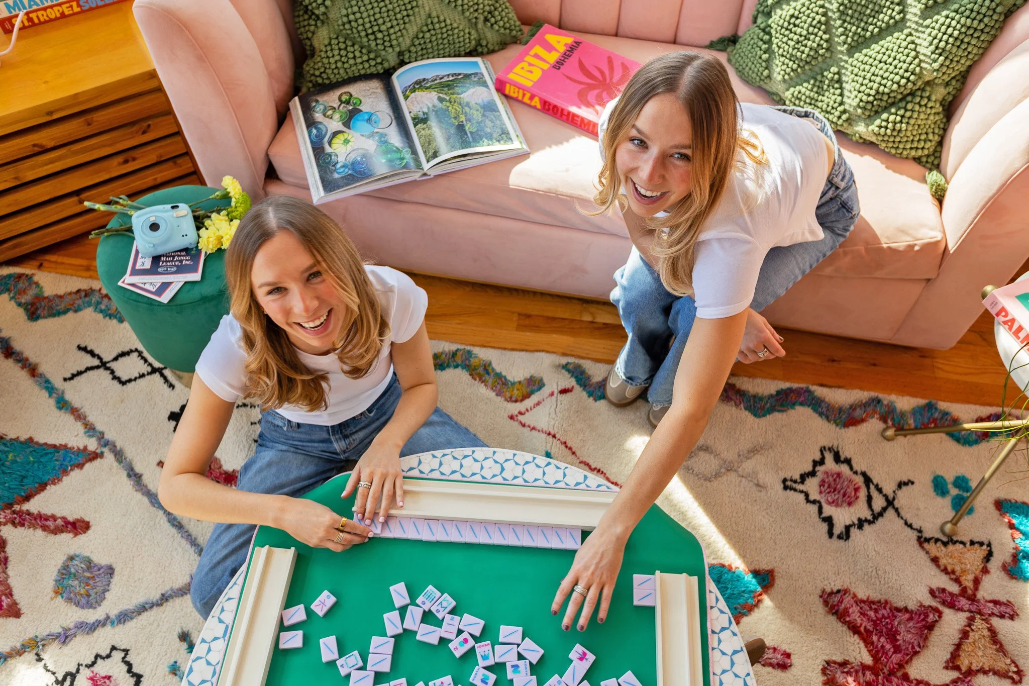 Two women setting up a Mahjong game