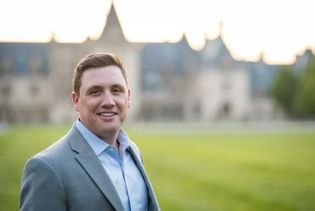 Logo of Opulent Construction Group featuring a stylized circular emblem with horizontal lines, and the company name in bold white letters on a black background.