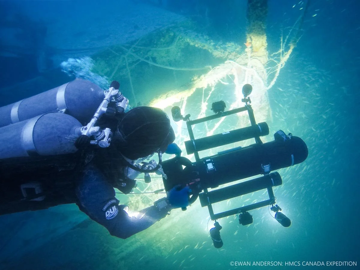 Photogrammetry specialist and expedition diver Roger Lacasse deploys a camera-and-lighting sled to document the wreck site.