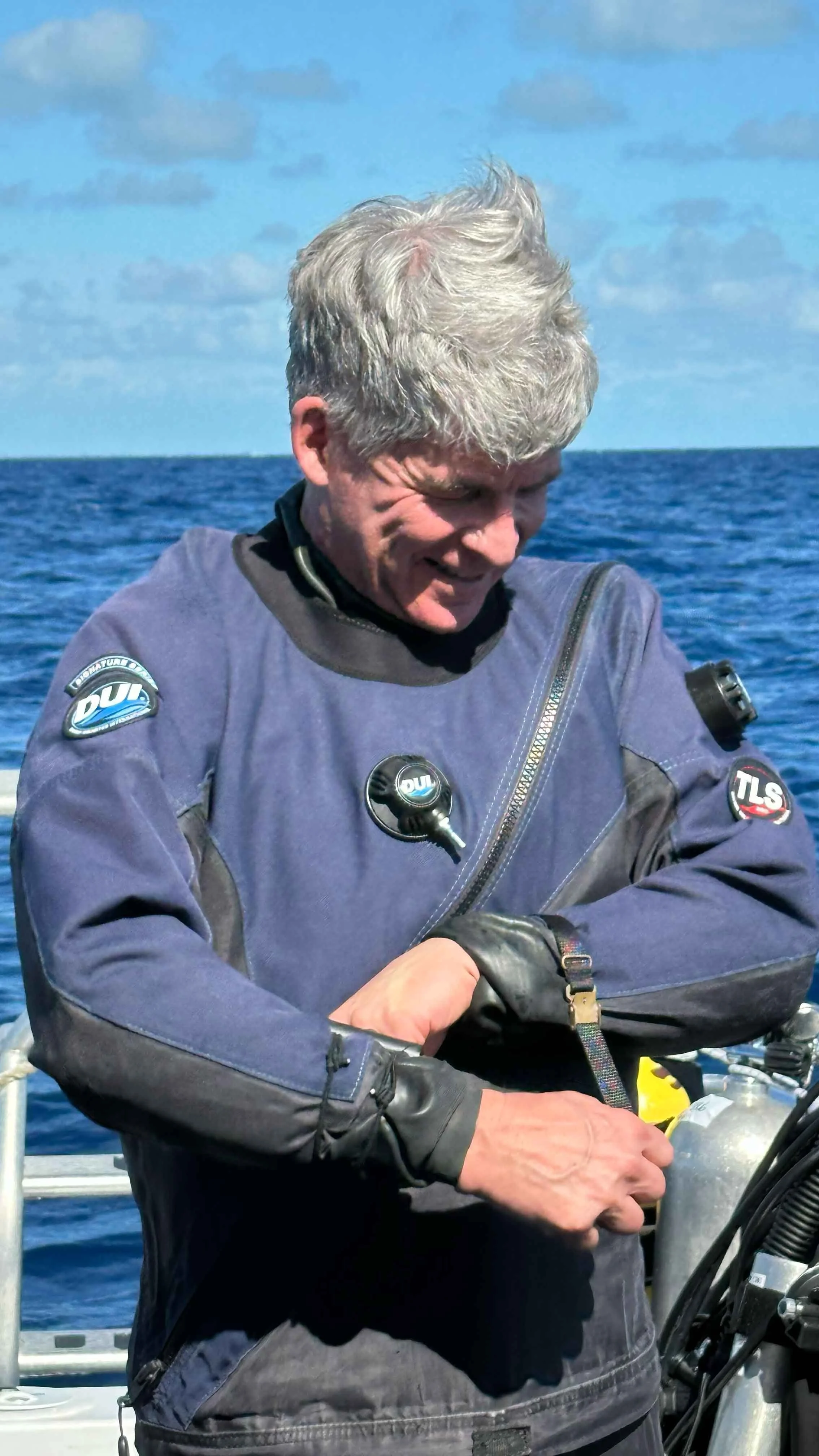 Roger Lacasse, 3D Photogrammetry Lead, suiting up for a dive on HMCS Canada.
