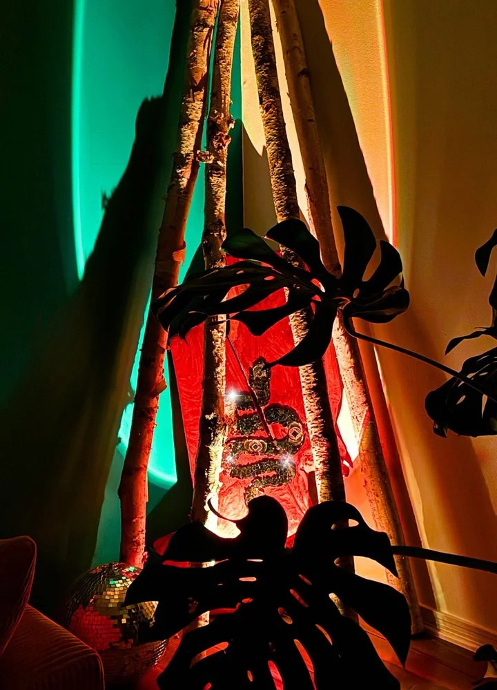 Colorful interior scene with green, yellow, and red lighting at Joytown, a transformational retreat & tantra sanctuary in Colorado.