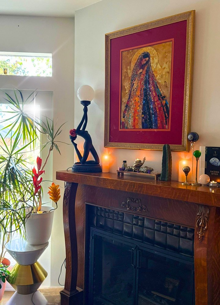 A living room corner featuring a wooden mantle with decorative objects at Joytown, a transformational retreat & tantra sanctuary in Colorado.