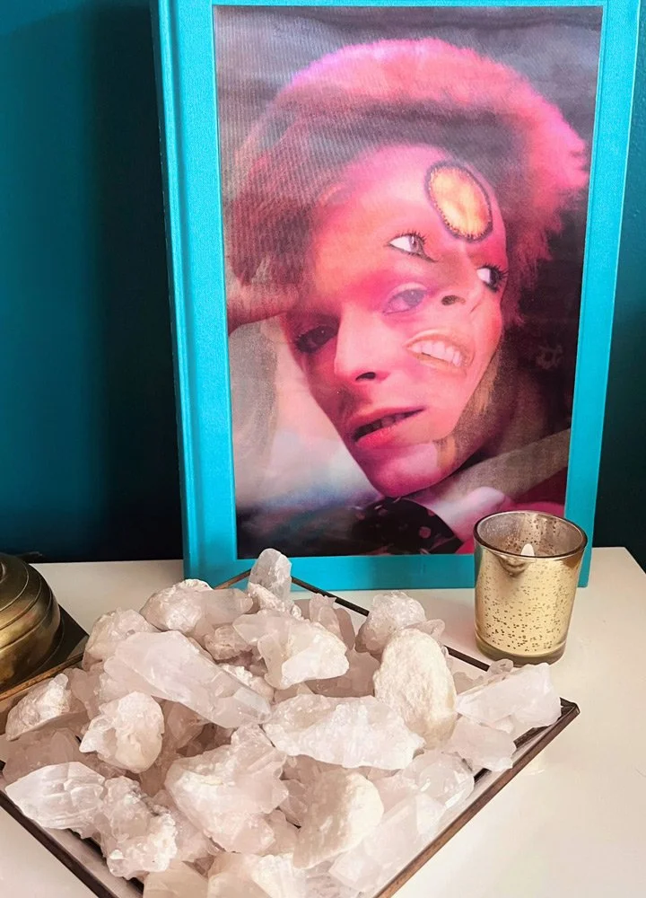 A framed and layered portrait of David Bowie at Joytown, a transformational retreat & tantra sanctuary in Colorado.