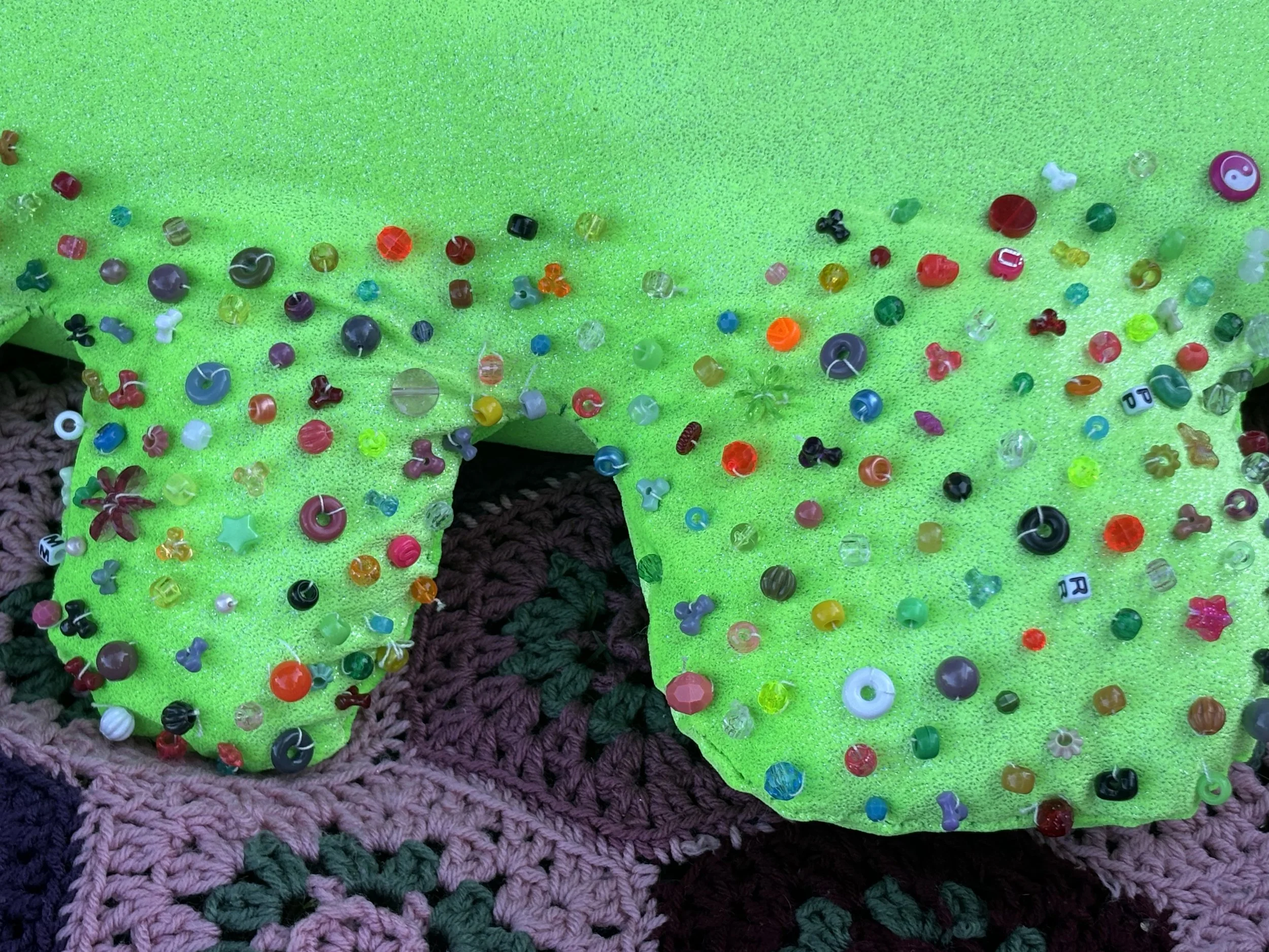 "Special flower," fabric and hand beading, reclaimed filler, May 2025.