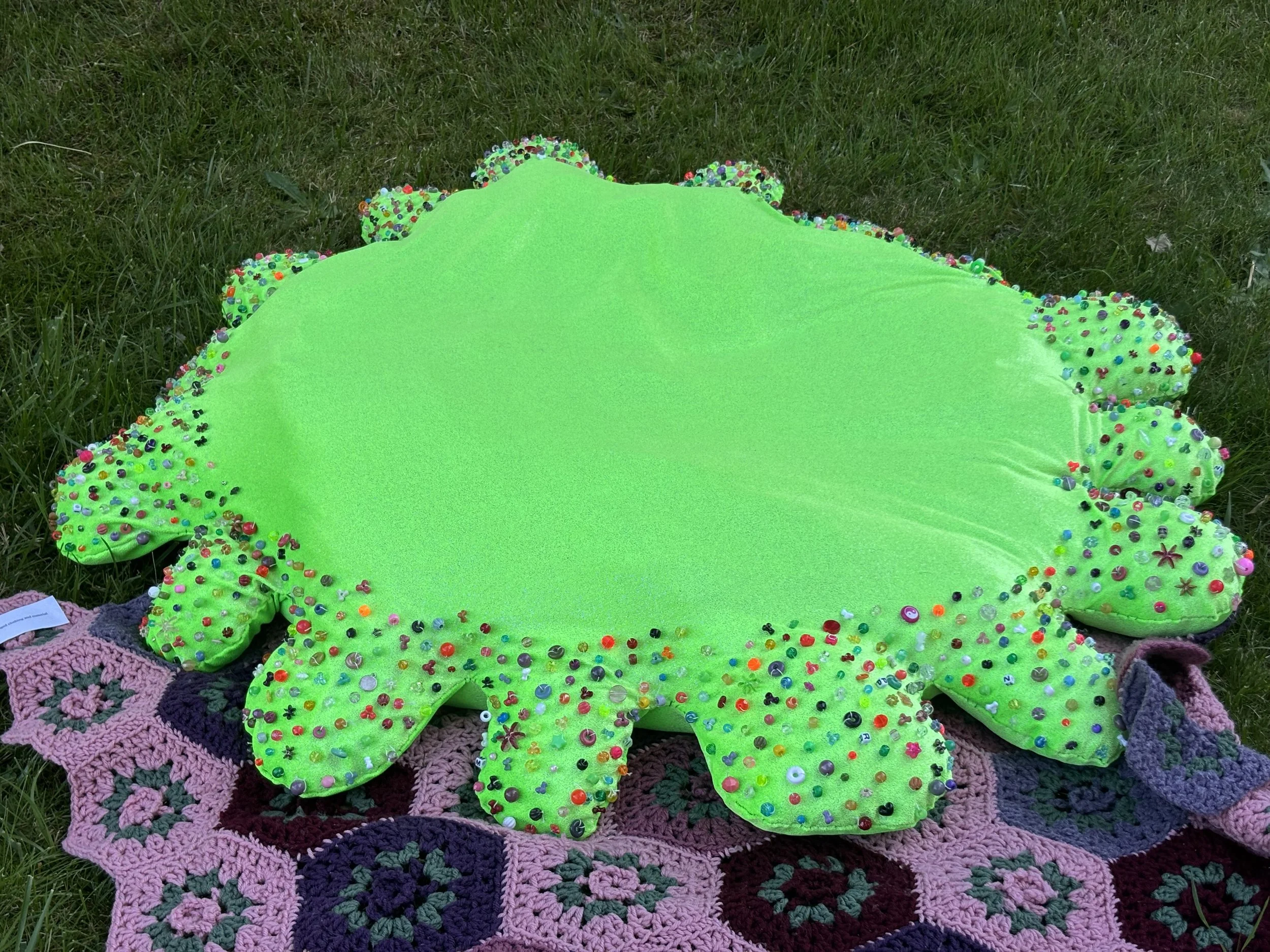 "Special flower," fabric and hand beading, reclaimed filler, May 2025.