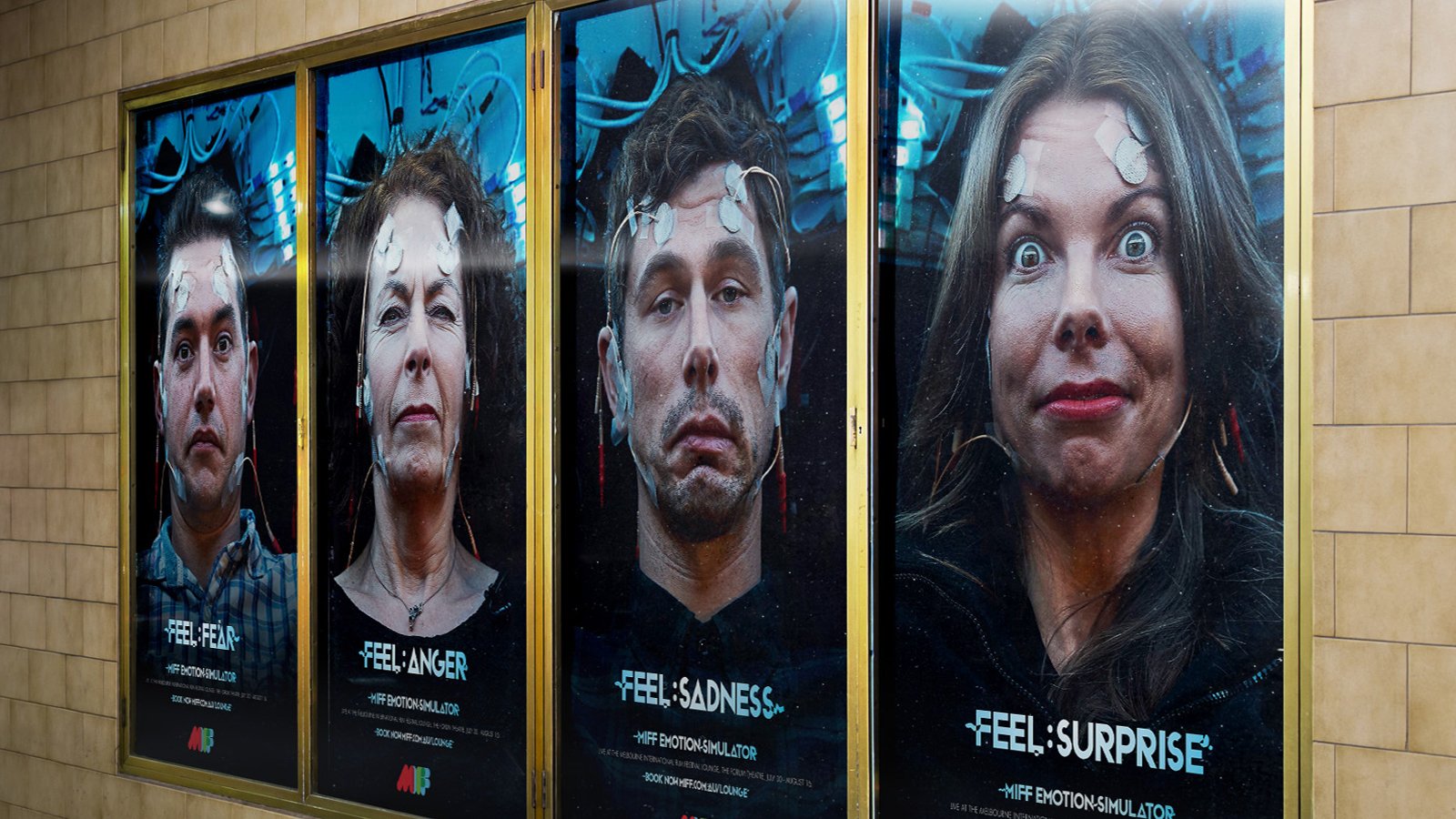 Four posters showing people with emotion-detecting sensors, labeled with emotions: fear, anger, sadness, surprise. MIFF Emotion Simulator advertisement.