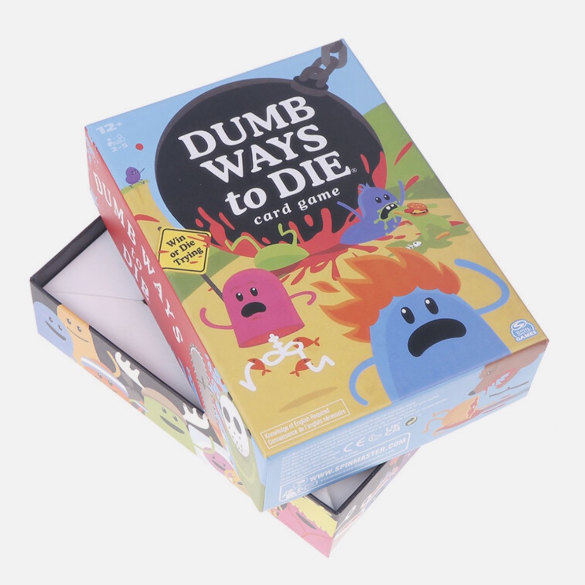 Card game box titled 'Dumb Ways to Die' with cartoon monsters and a sign saying 'Win or Die Trying'