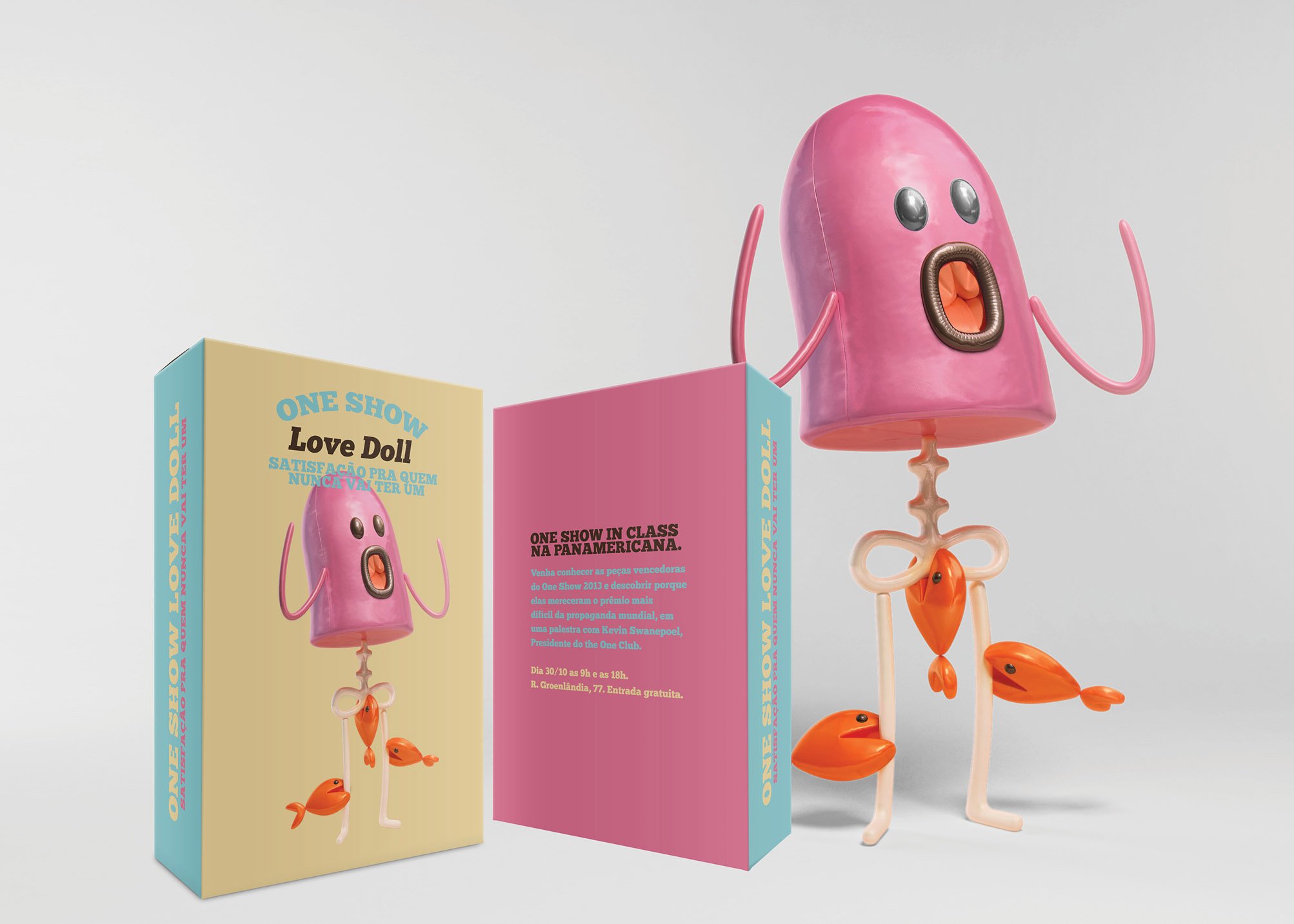 A pink plastic figure with fish legs, arms, and eyes, featuring a wide, open mouth, standing next to a promotional display with information about a show and a pink and blue backdrop.