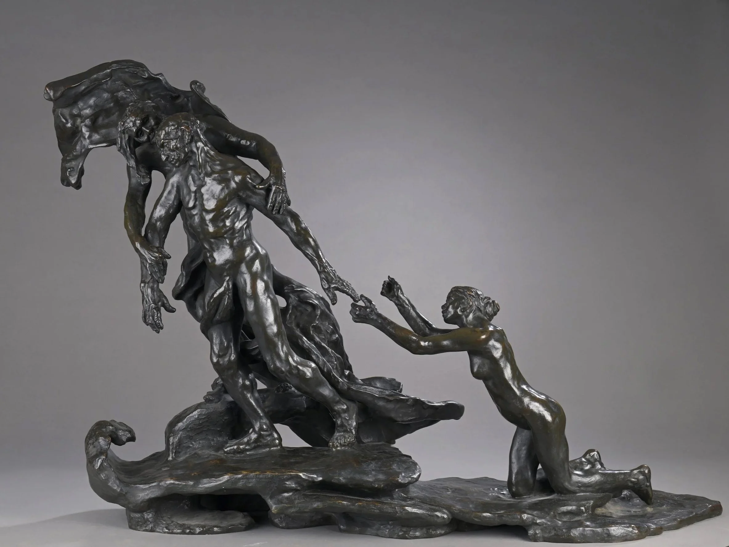 Bronze sculpture "Orpheus and Eurydice" by Auguste Rodin, depicting two figures, with Orpheus leading Eurydice, who is following on her knees.