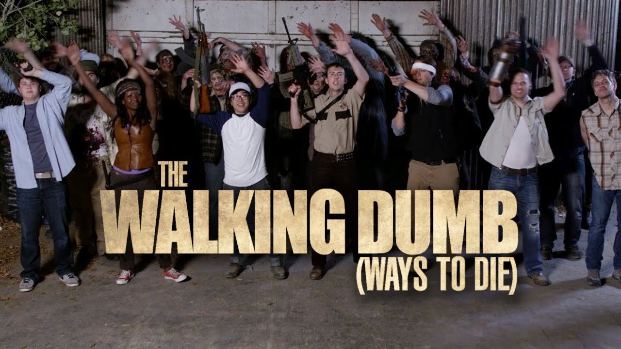 People raising their hands in a crowdsourced photo with the title 'The Walking Dumb (Ways to Die)' in large bold text at the bottom.