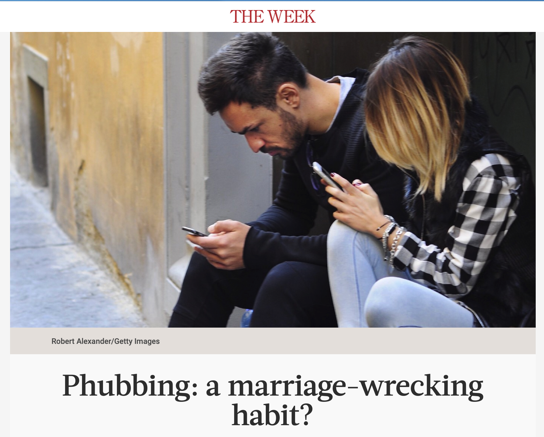 Two people sitting against a wall, looking at their smartphones, with 'THE WEEK' logo and caption 'Phubbing: a marriage-wrecking habit?'