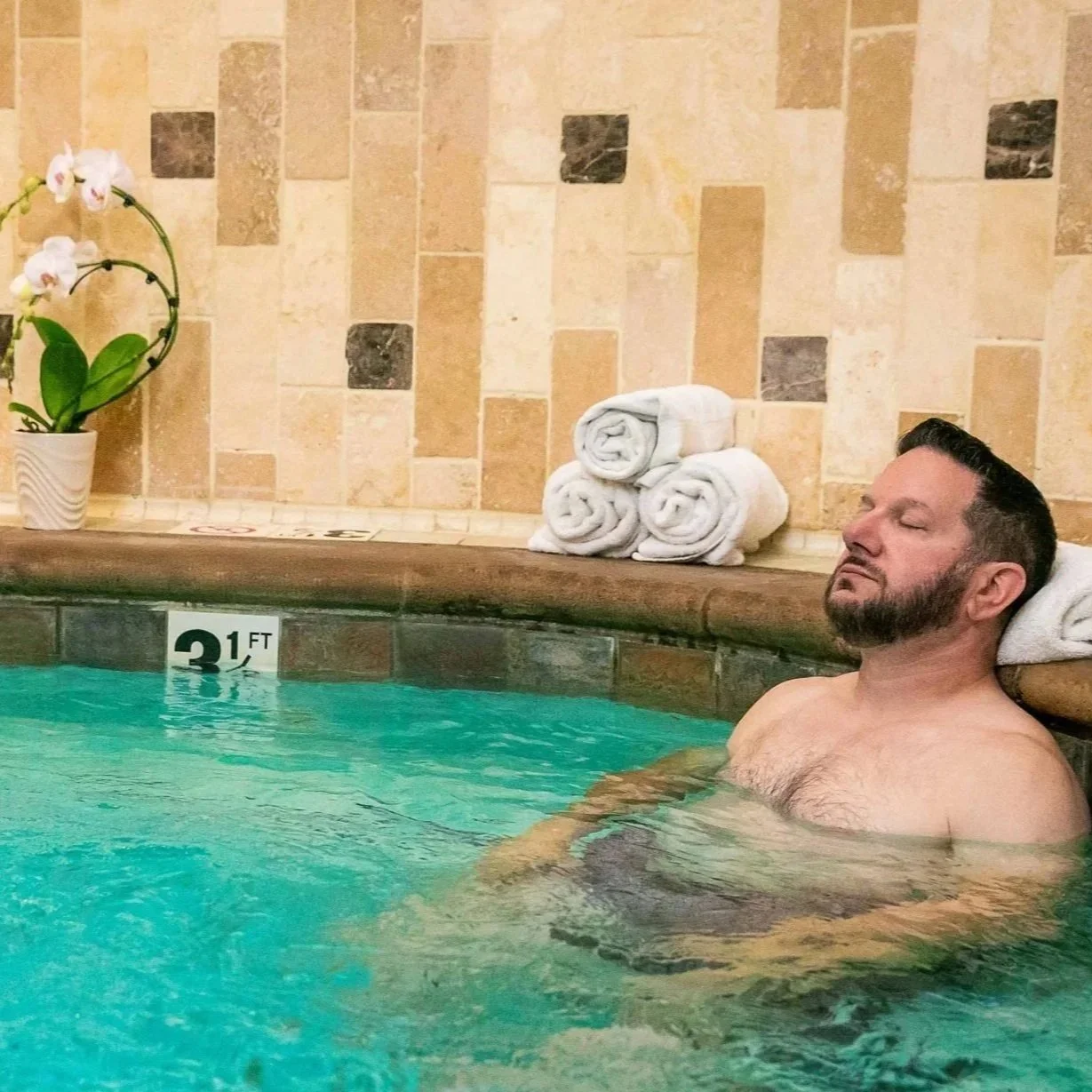 Guest relaxing in the whirlpool tub at The Ivy Day Spa in Santa Clarita, enjoying spa amenities for stress relief.