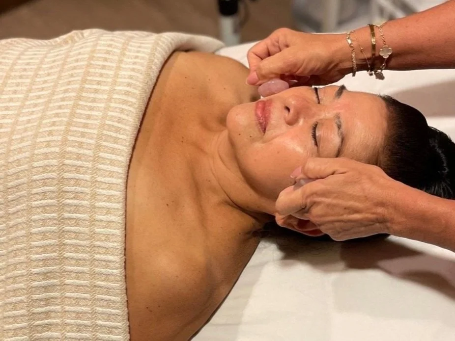 Woman receiving a rejuvenating facial treatment at The Ivy Day Spa in Santa Clarita, guided by a professional esthetician.