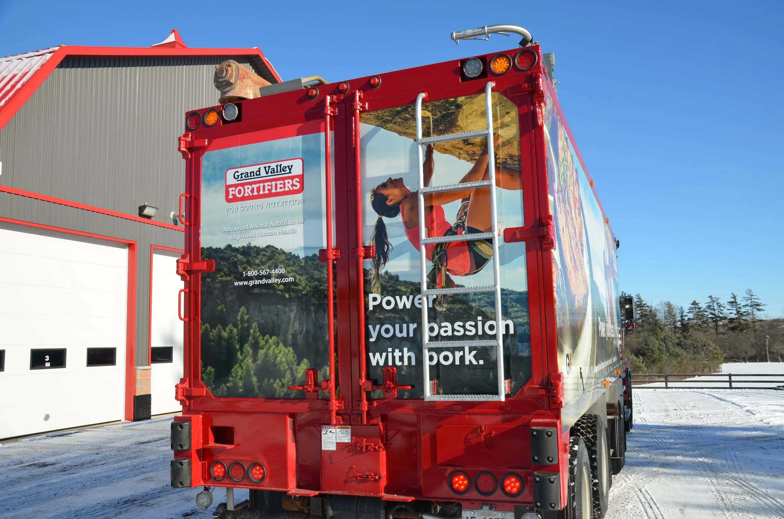 Grand Valley Fortifiers Power your passion with pork feed truck 3M wrap rear view