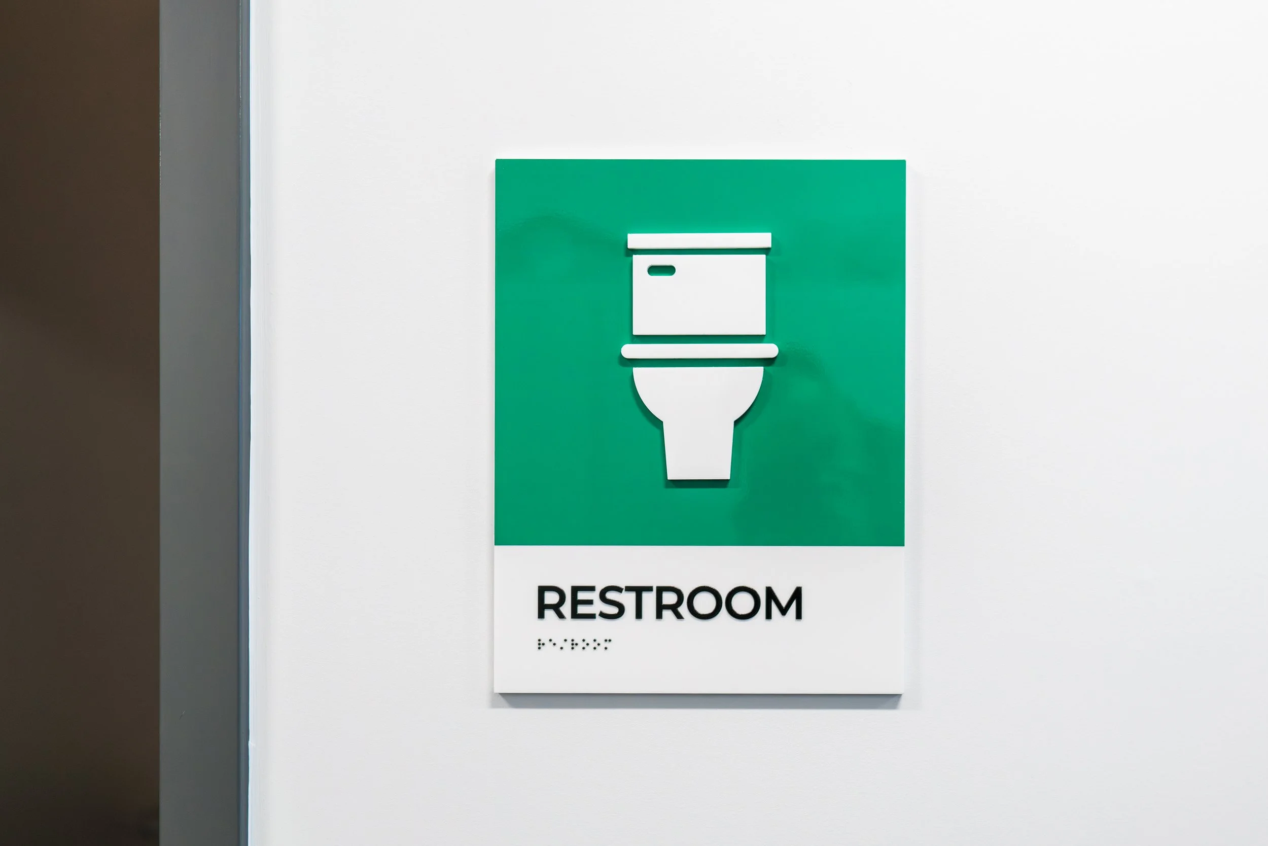 YNCU dimensional acrylic restroom sign with tactile letters and braille