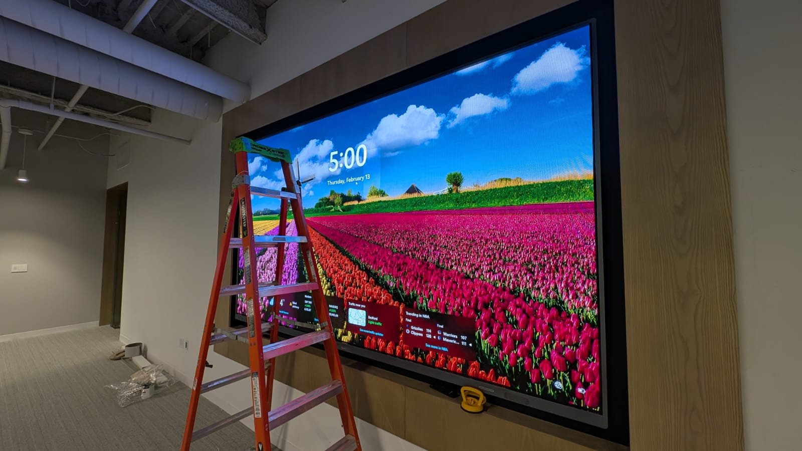 A large flat-screen digital display mounted on a wall.