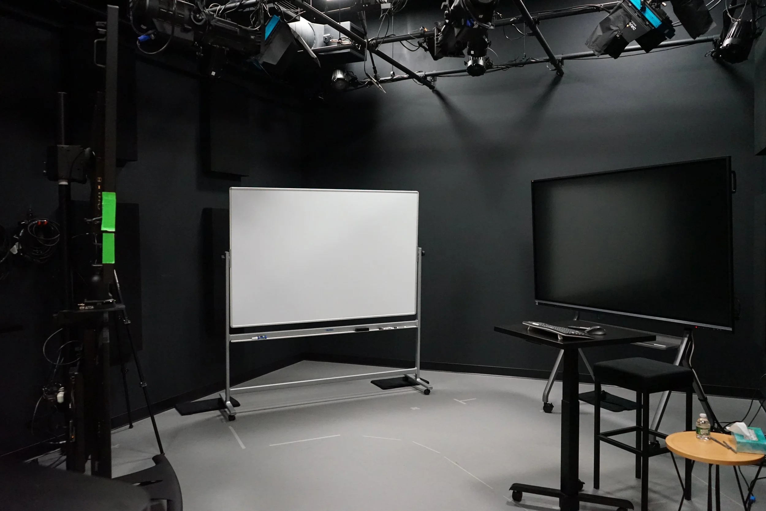 Interior of a modern office with large screens displaying a video call.