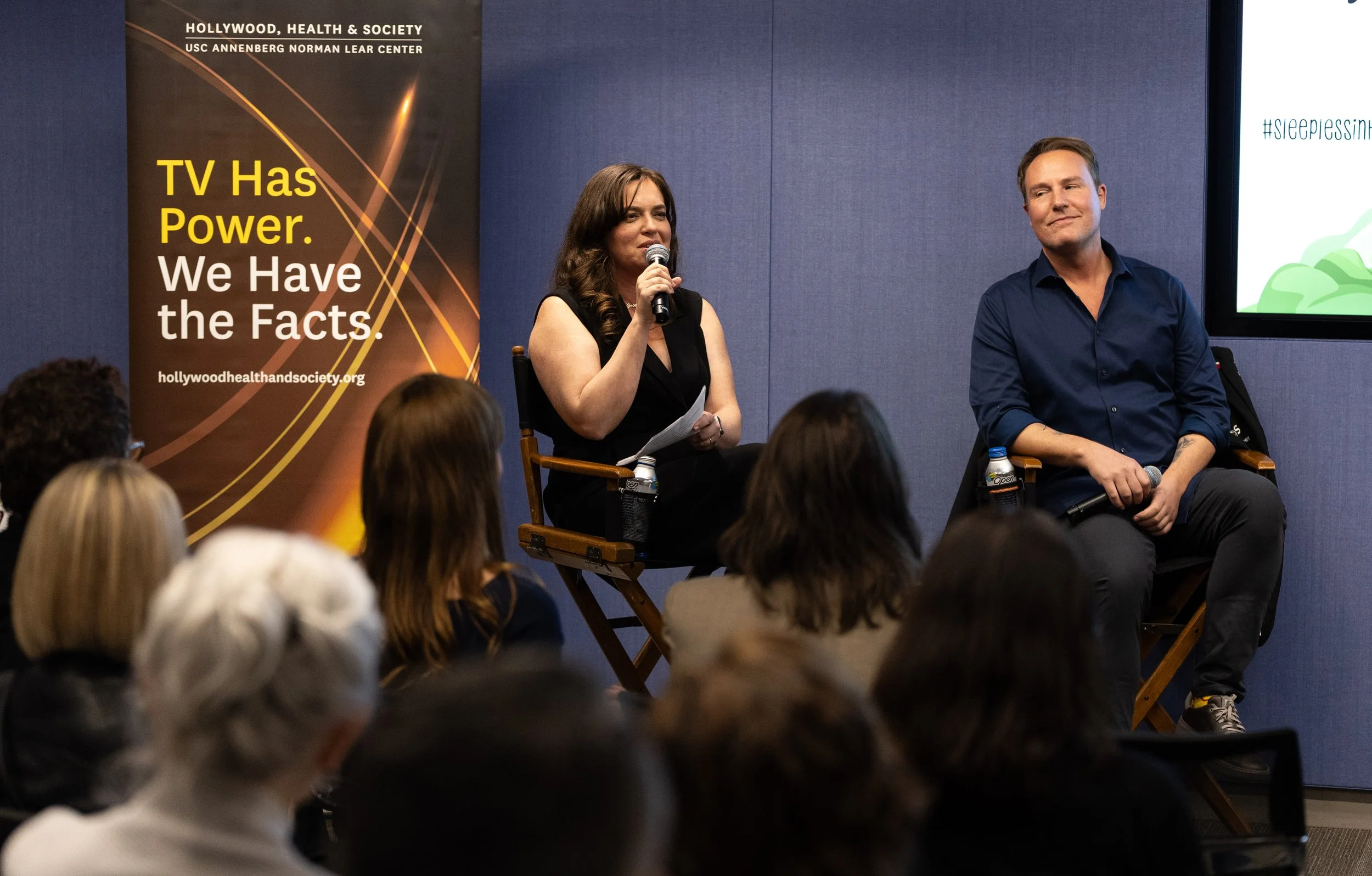 Lindsay Scola speaking onstage during a Hollywood, Health & Society panel discussion on sleep.