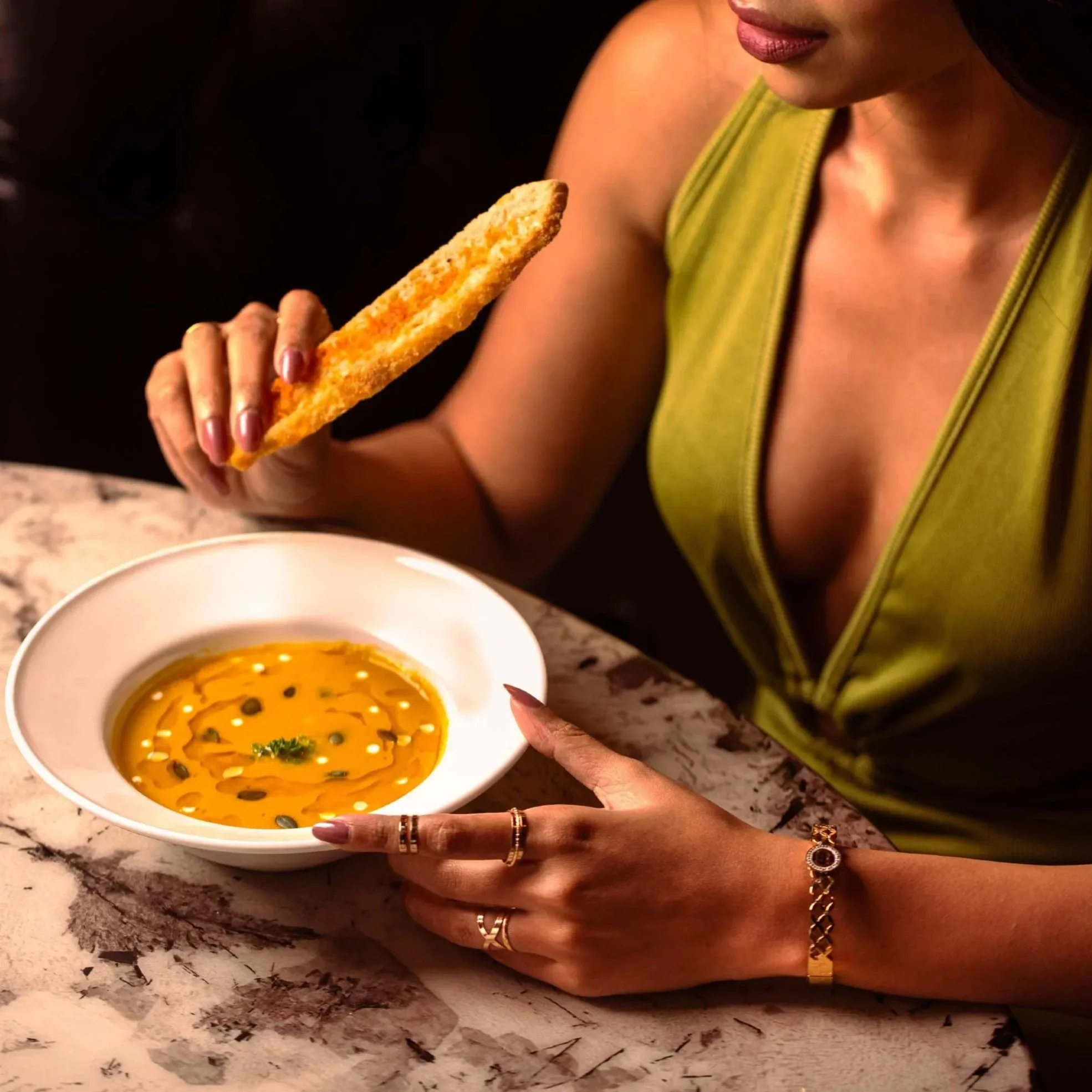 Creative lifestyle food photography featuring a model dining at Cafe Dolce with pumpkin soup, showcasing high-end restaurant branding by Showmo Films.