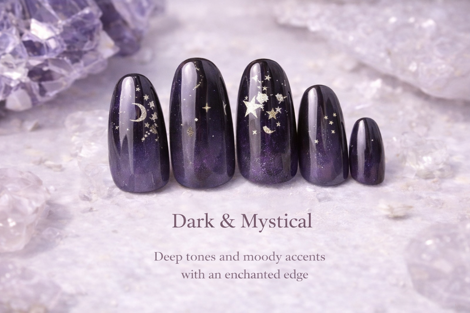 Five dark purple to black watercolor-style nails with celestial gold accents, with a background of purple crystals and white crystal-like surface. Text overlays read 'Dark & Mystical' and 'Deep tones and moody accents with an enchanted edge.'