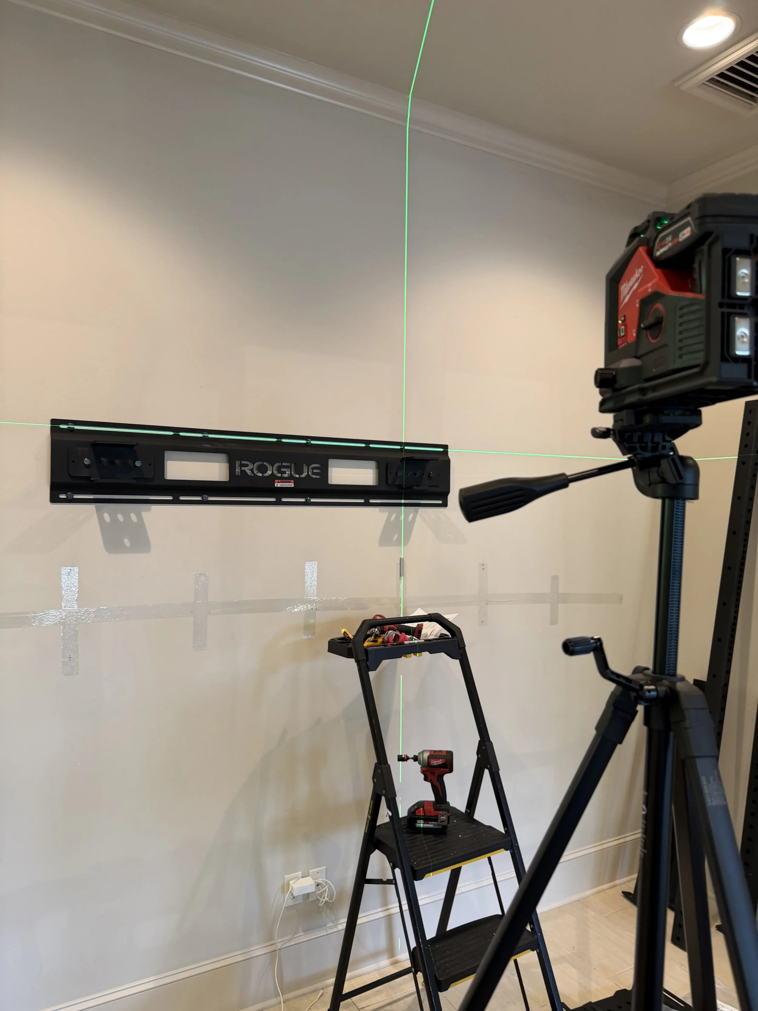 Precision leveling Rogue Fitness wall-mounted rack.