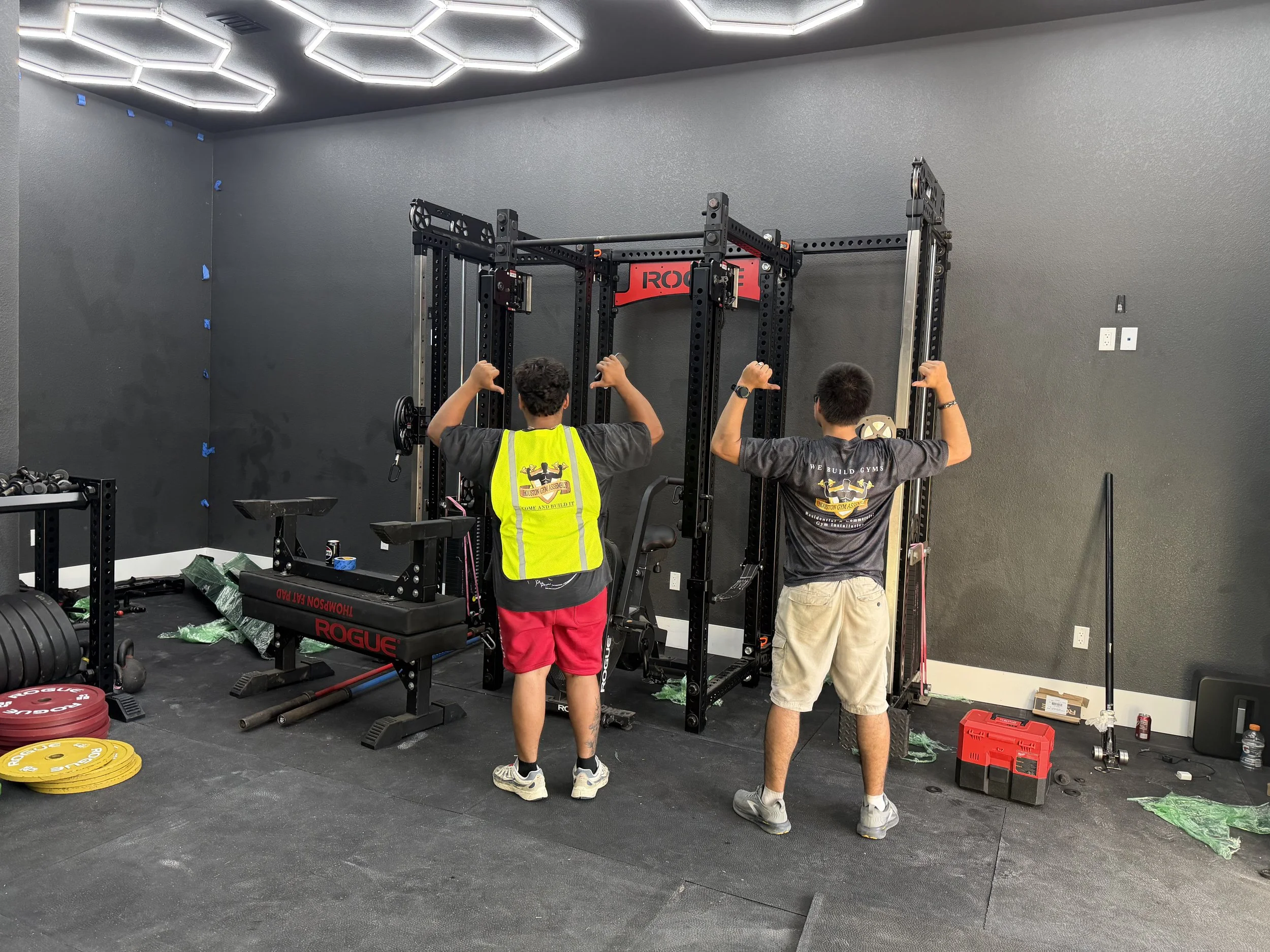 Houston Gym Assembly technicians installing a Rogue Monster Rig in a residential home gym.