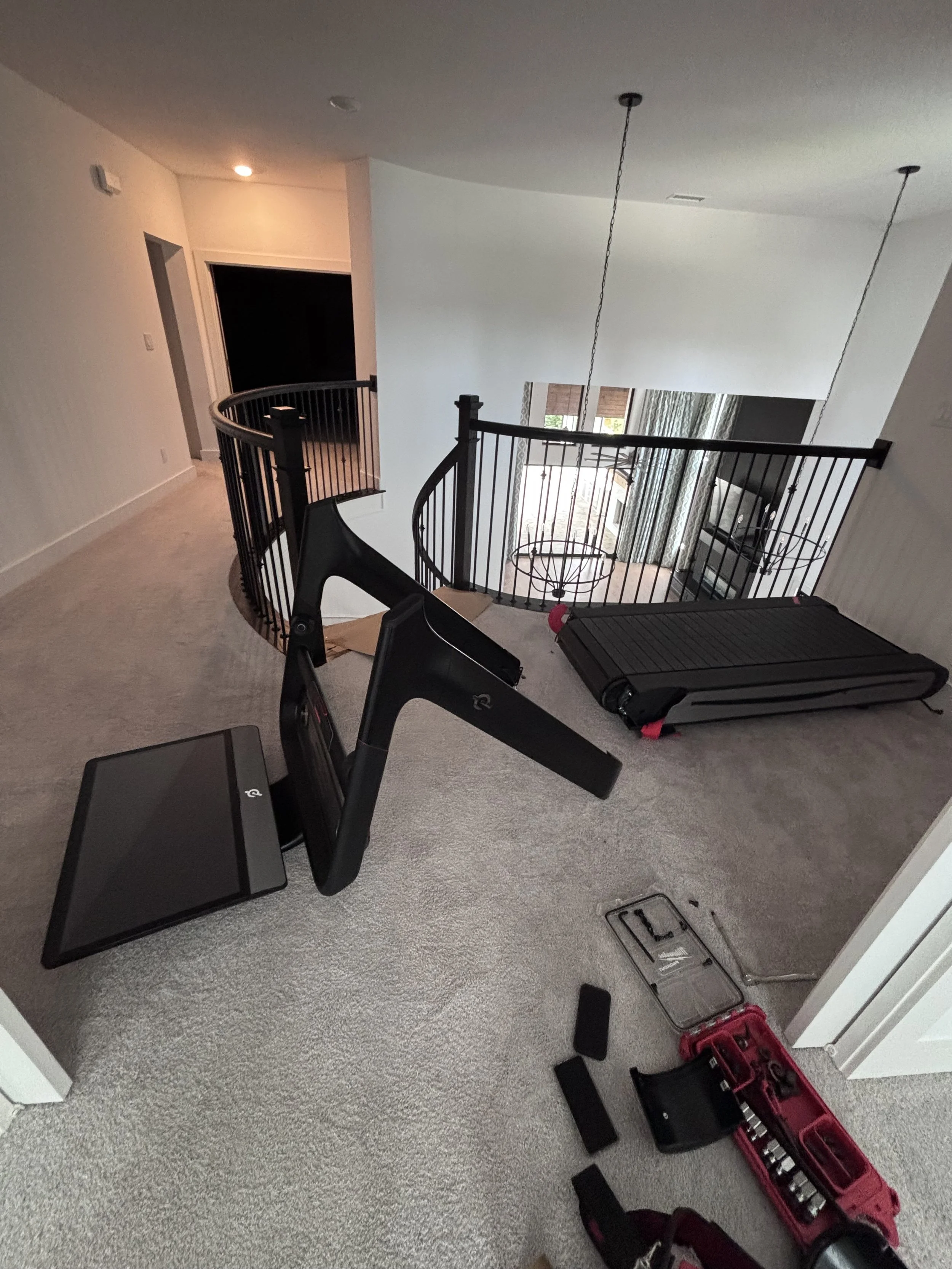 Peloton Tread Plus disassembled and prepared for a downstairs relocation in a Houston home