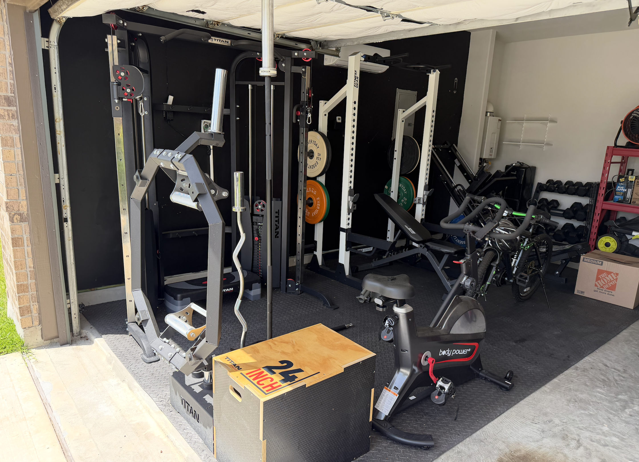 Home gym equipment in a garage before fitness equipment relocation.