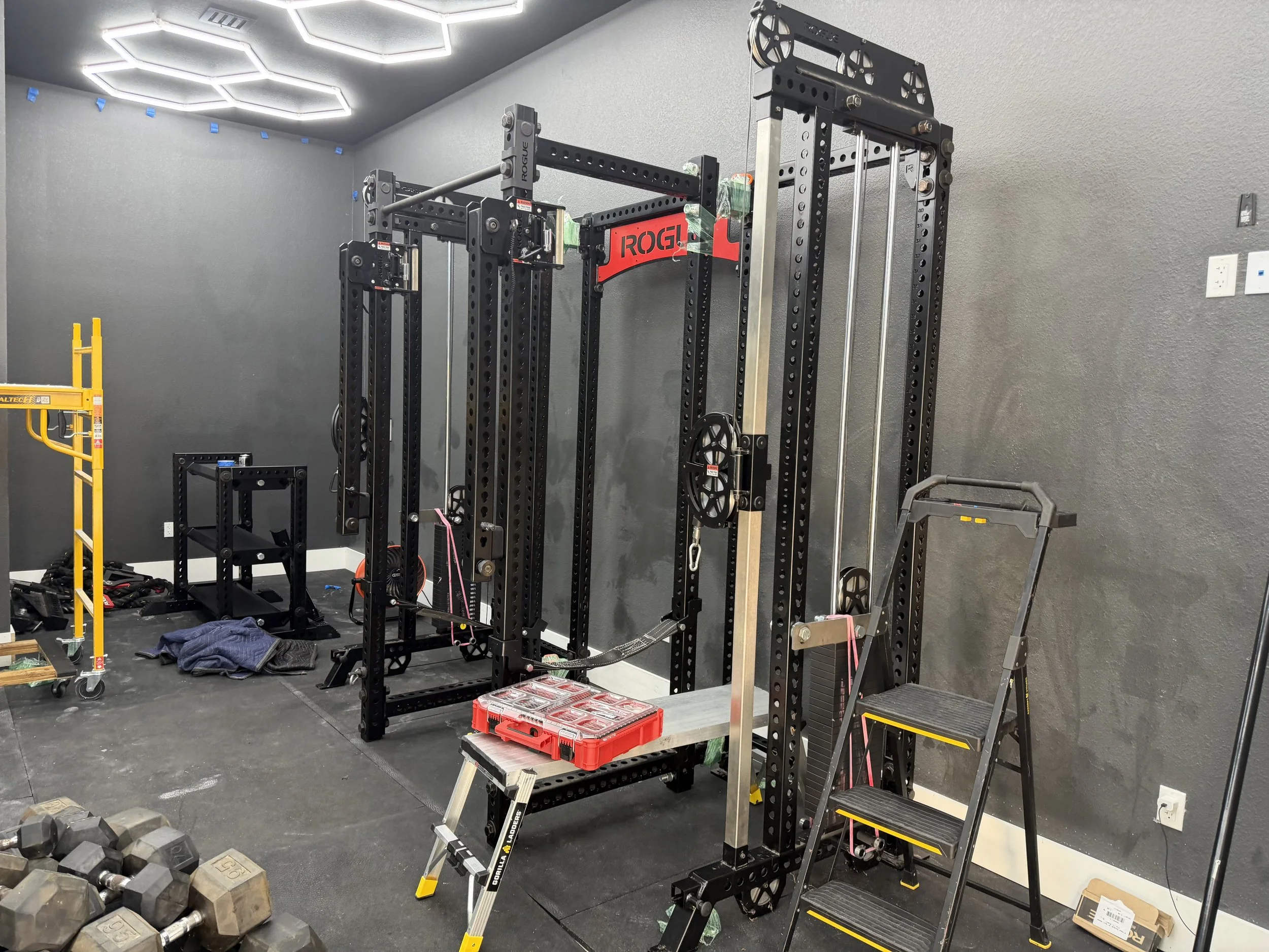 Rogue Monster Cave strength training system being assembled by Houston Gym Assembly in a residential home gym in Houston, TX
